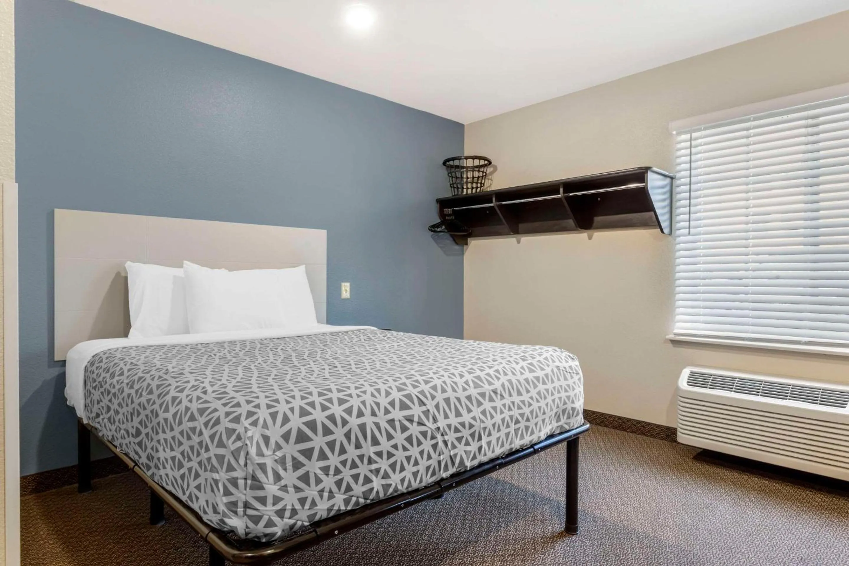 Bedroom, Bed in WoodSpring Suites Raleigh Garner