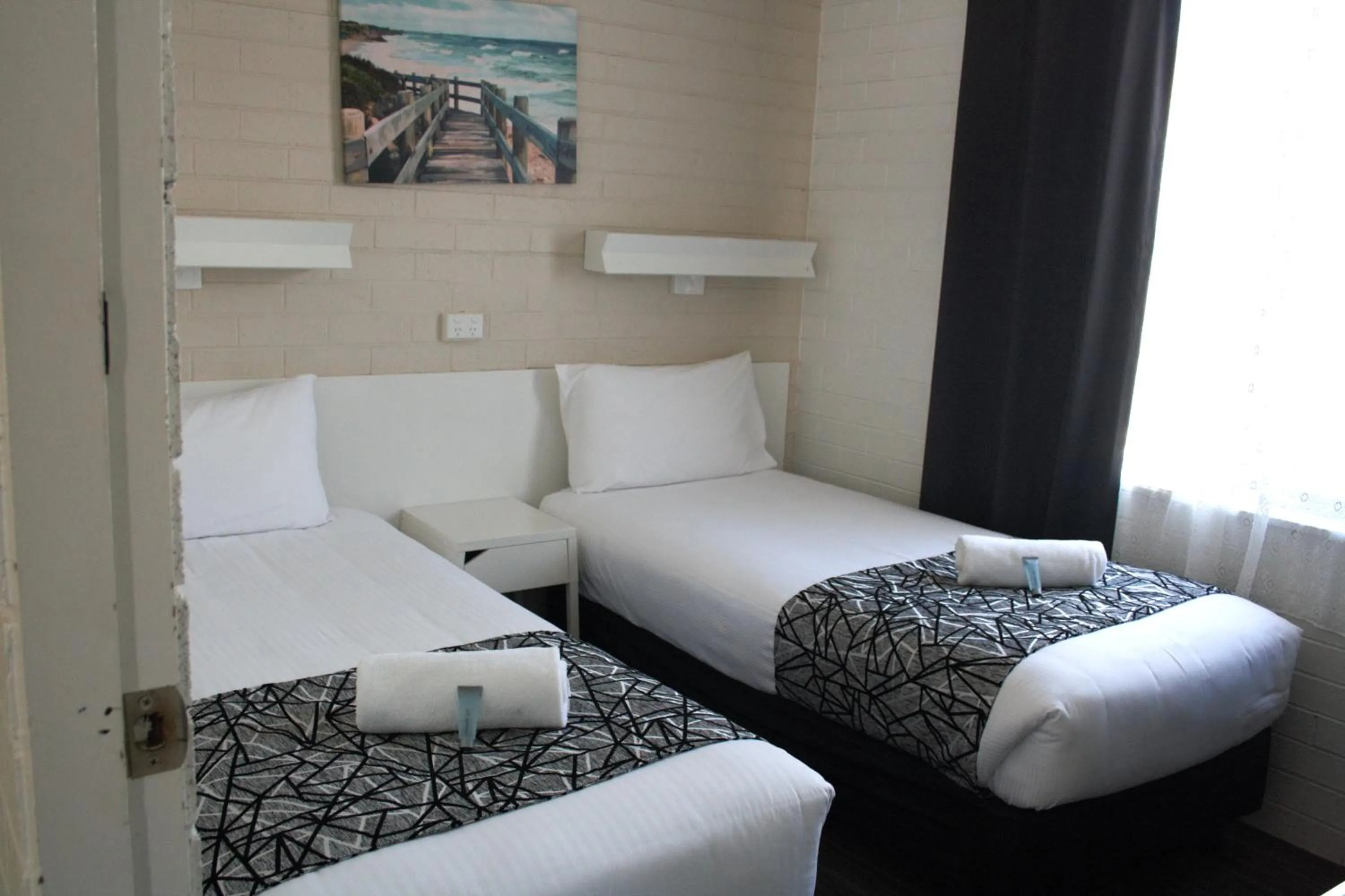 Bed in Coastal Bay Motel