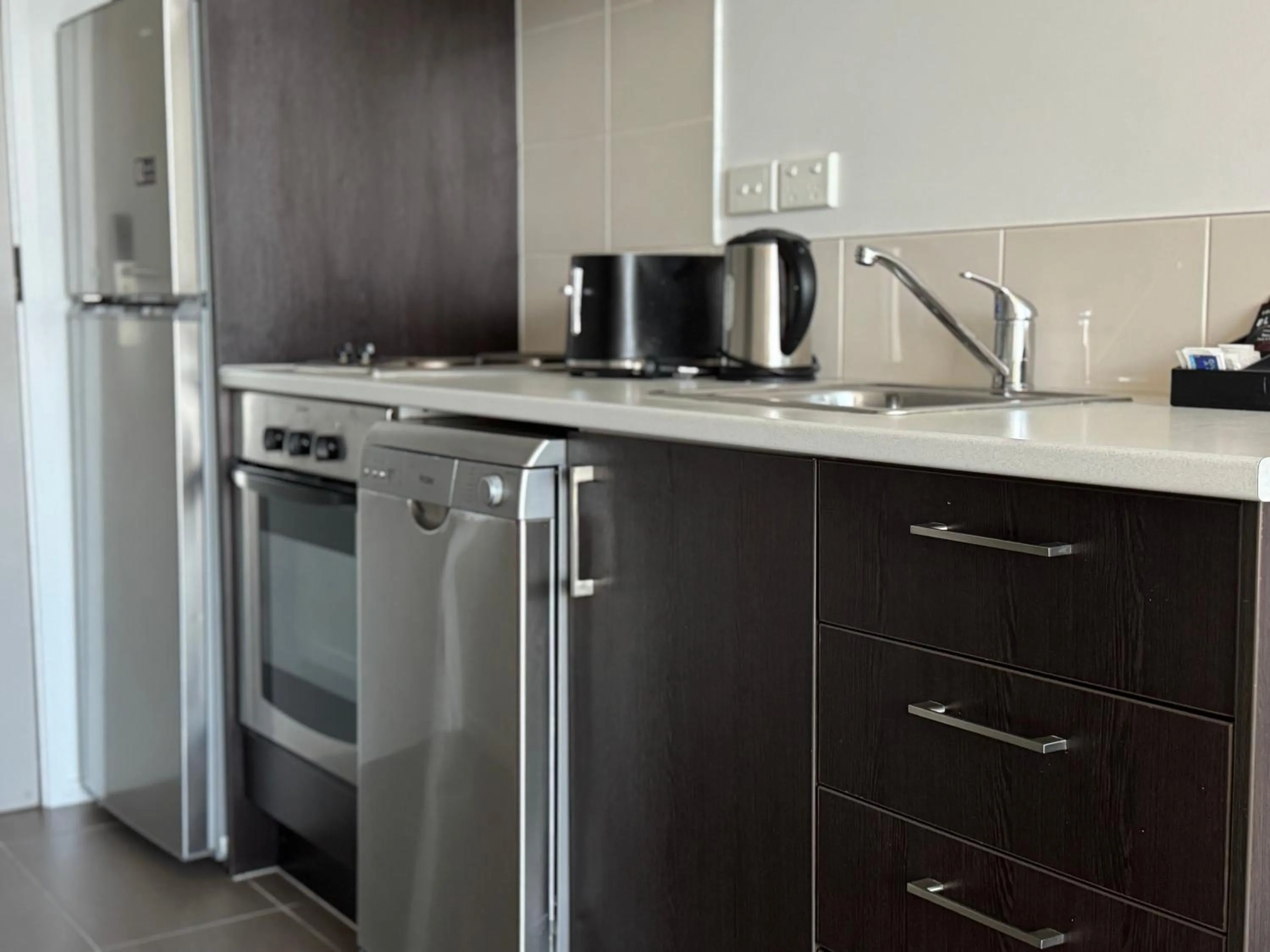 Kitchen or kitchenette in Quest Henderson, Auckland Apartment Hotel