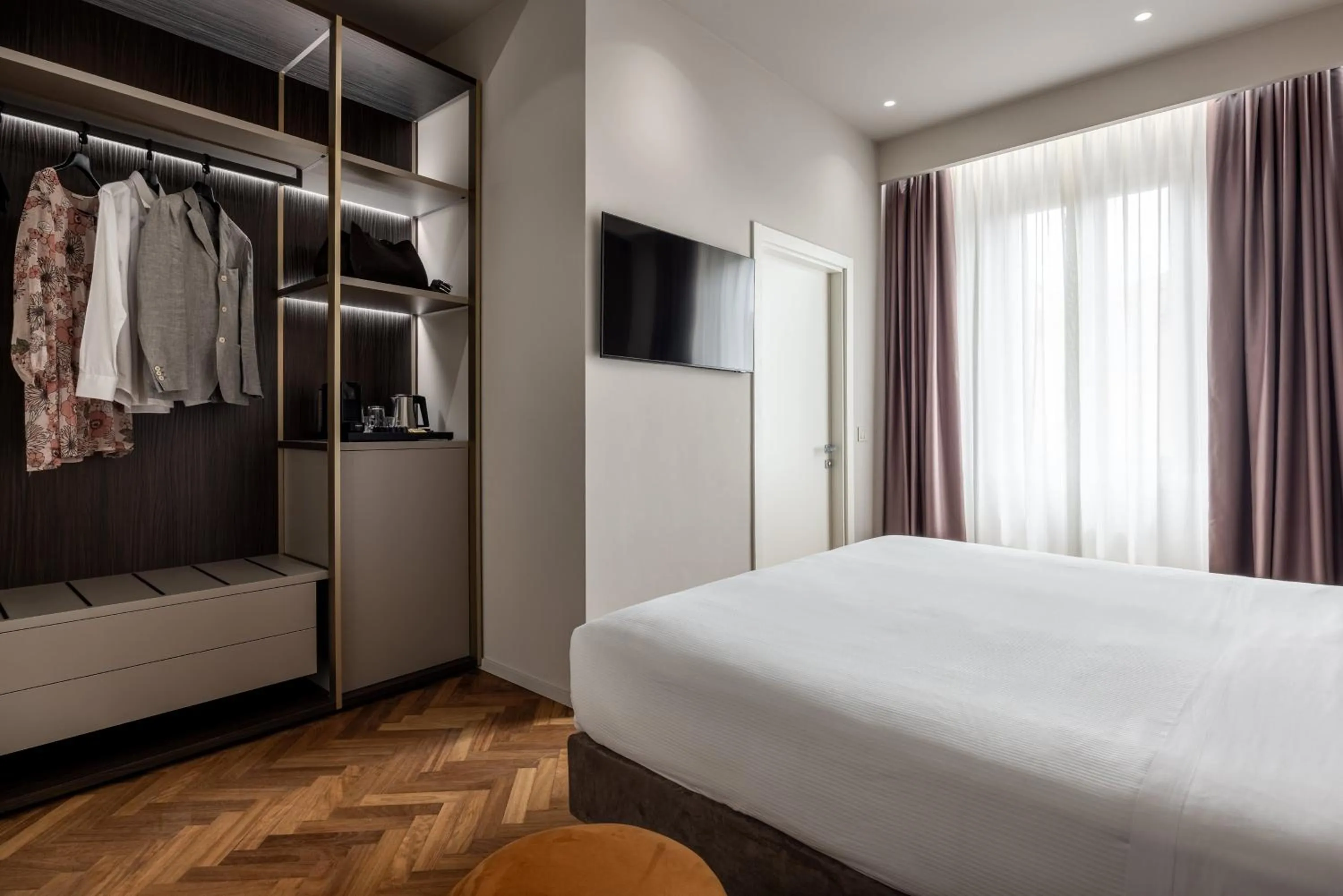 Bed in Aramis Deluxe Rooms