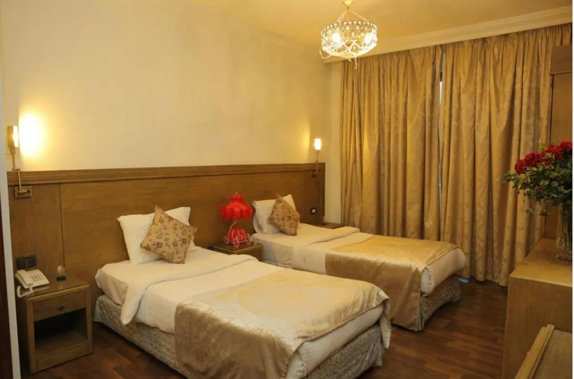 Bed in Royal Garden Hotel