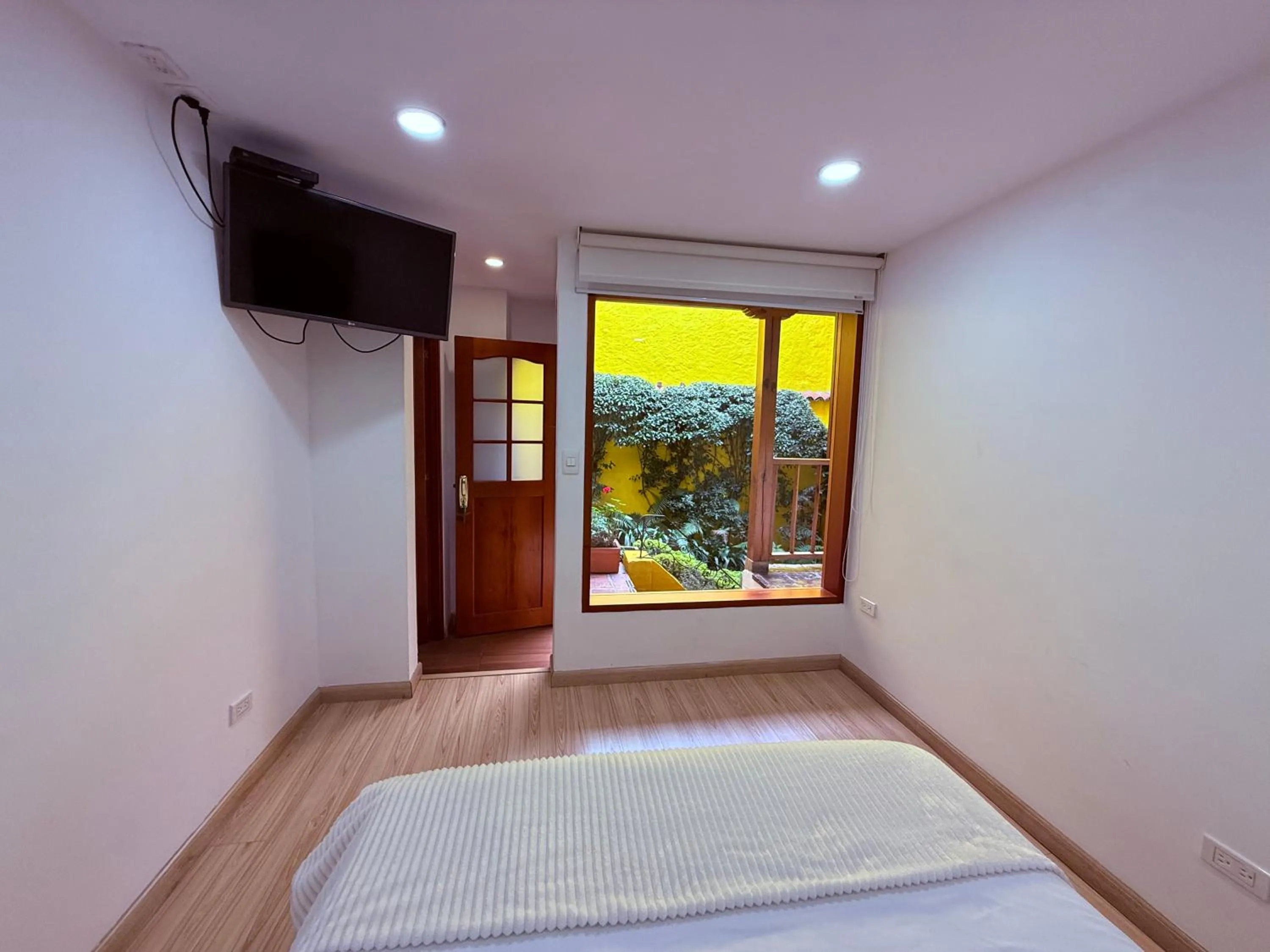 Garden view, Bed in Apartaestudios La Candelaria