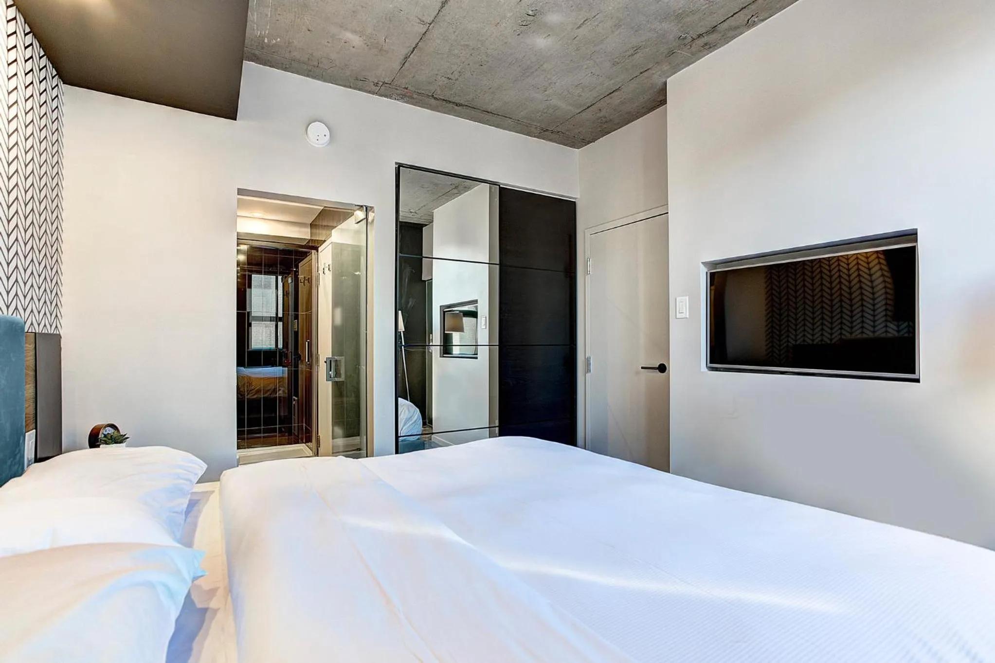 Bed in Pierce Boutique Apartments by Simplissimmo