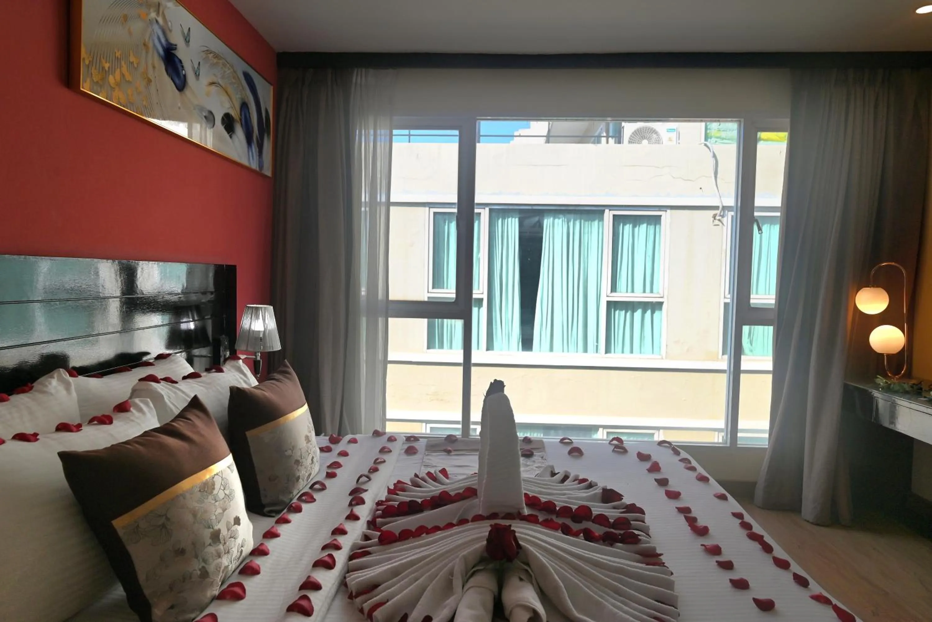 Bed in Boss Suites Nana Hotel