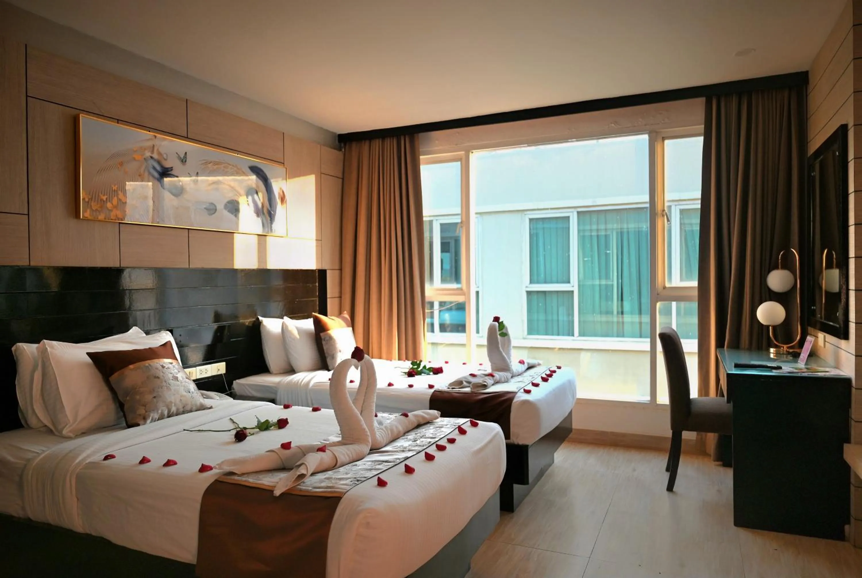 Bed in Boss Suites Nana Hotel