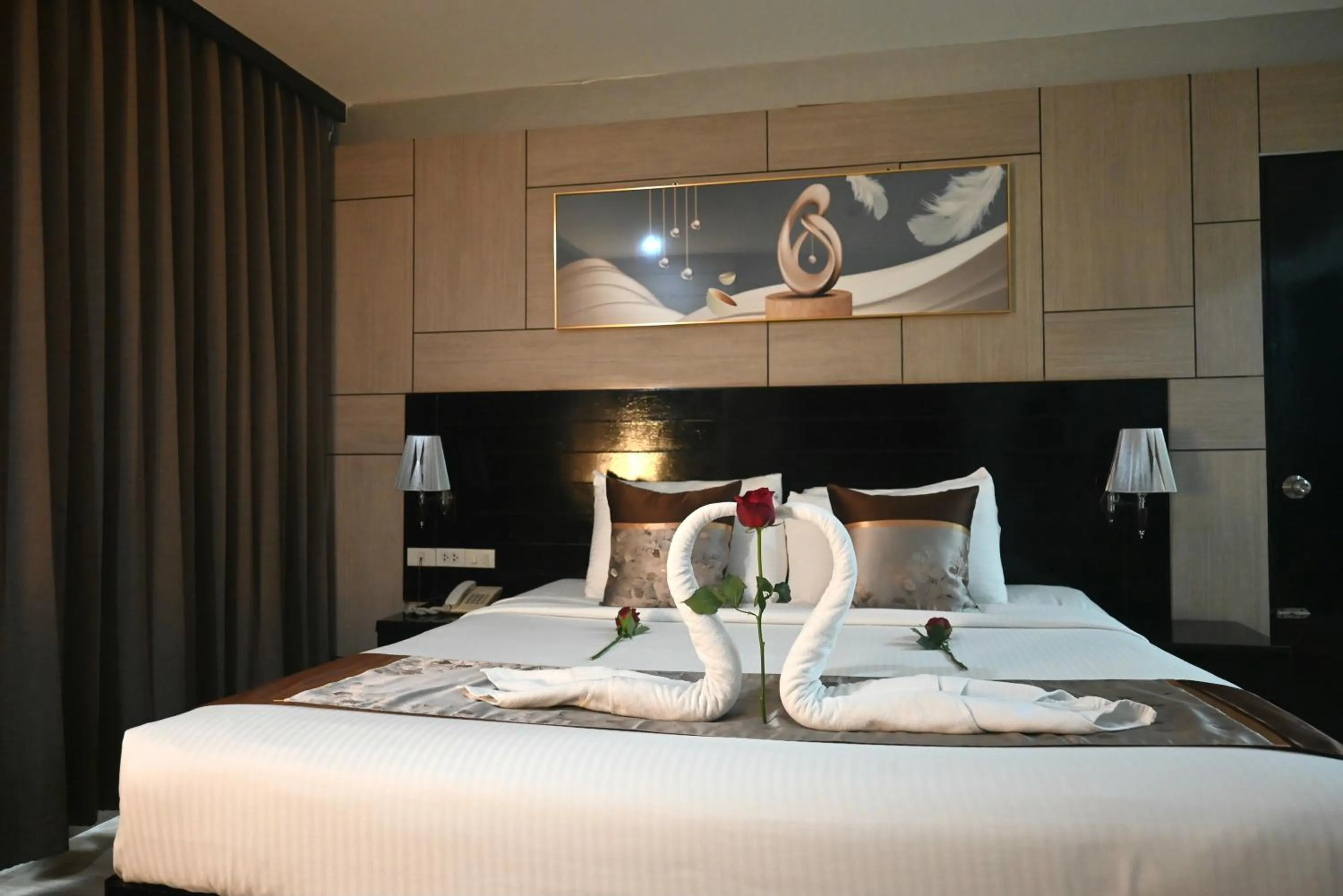 Bed in Boss Suites Nana Hotel