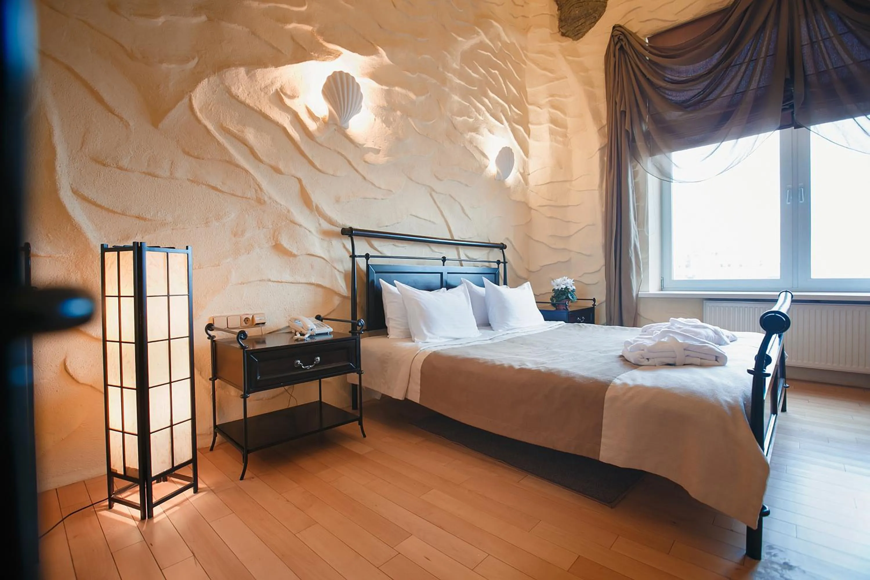 Bed in Tsunami Spa Hotel