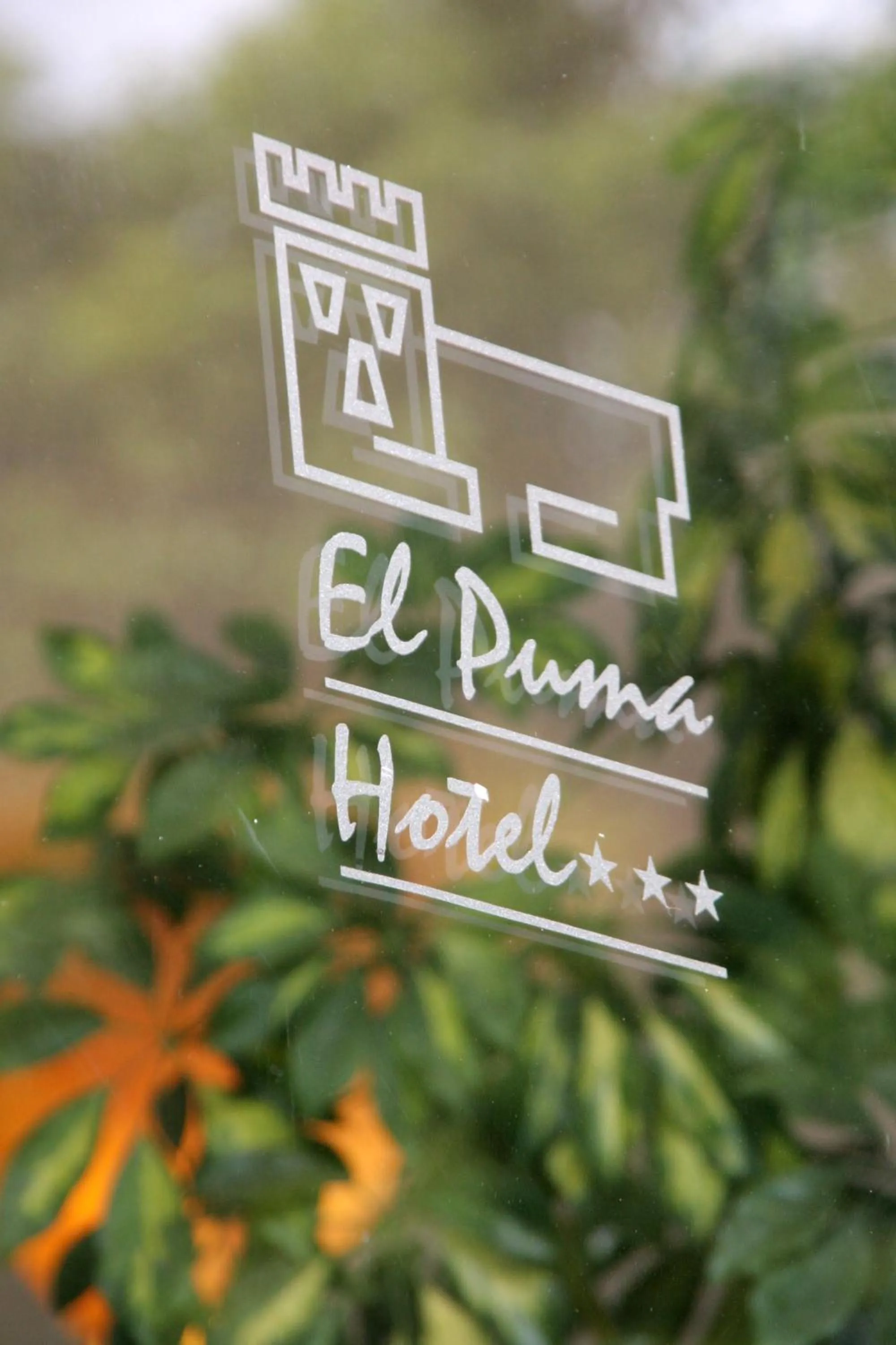 Property logo or sign in Hotel El Puma