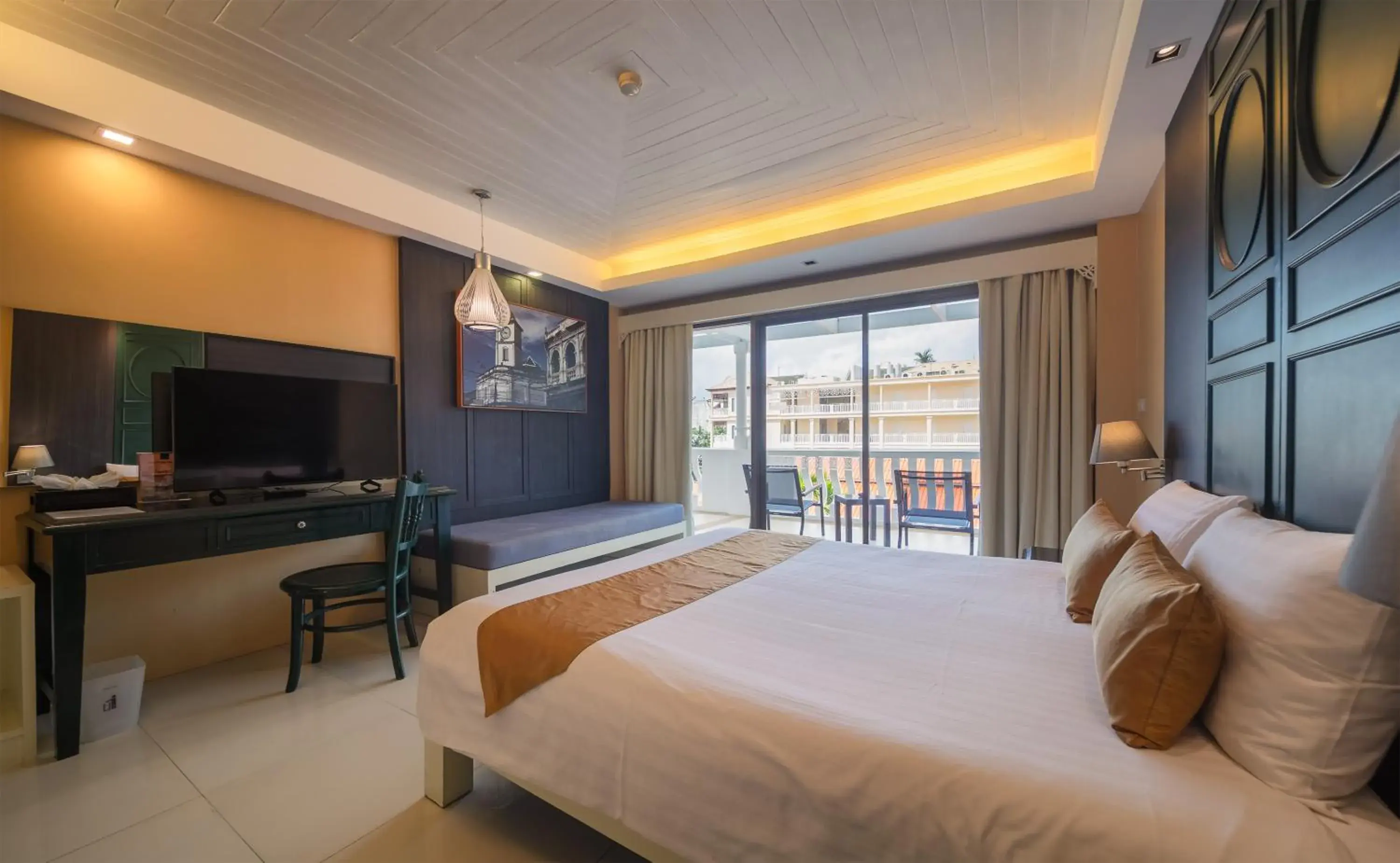 Communal lounge/ TV room, Bed in The Old Phuket - Karon Beach Resort Communal lounge/ TV room, Bed in The Old Phuket - Karon Beach Resort