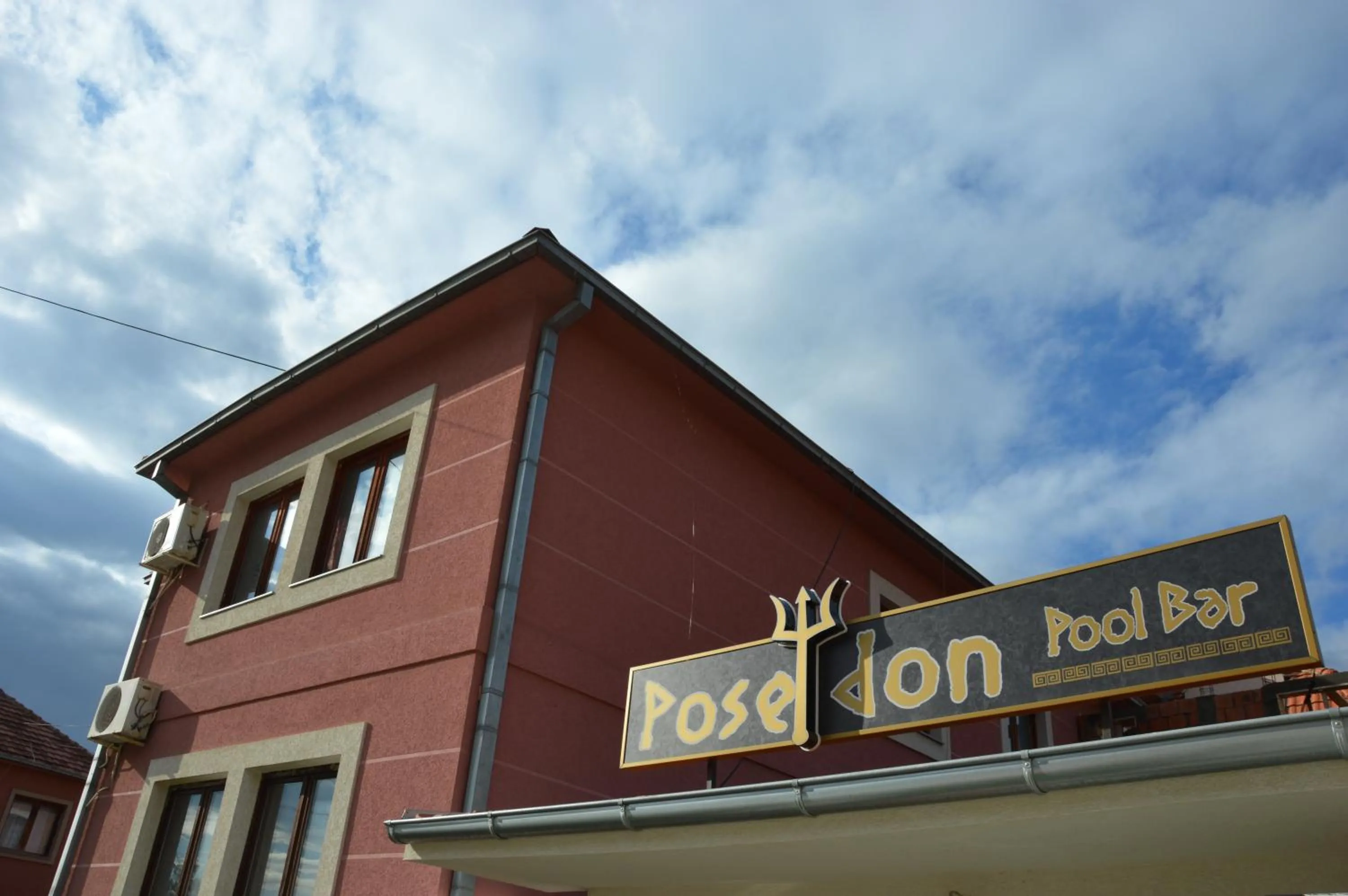 Property logo or sign in Poseidon Apartment