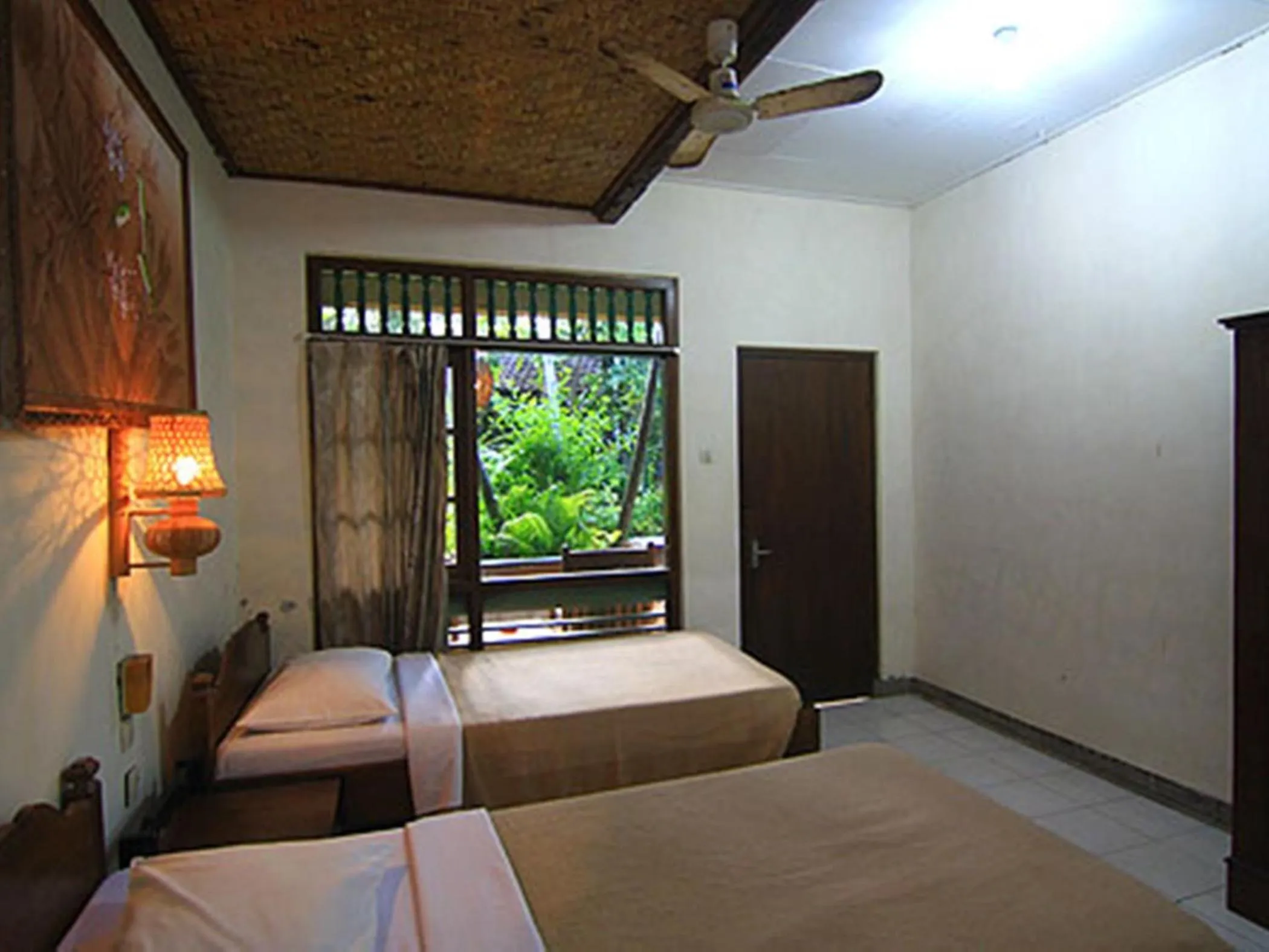 Photo of the whole room, Bed in Dewa Bharata Bungalows Candidasa