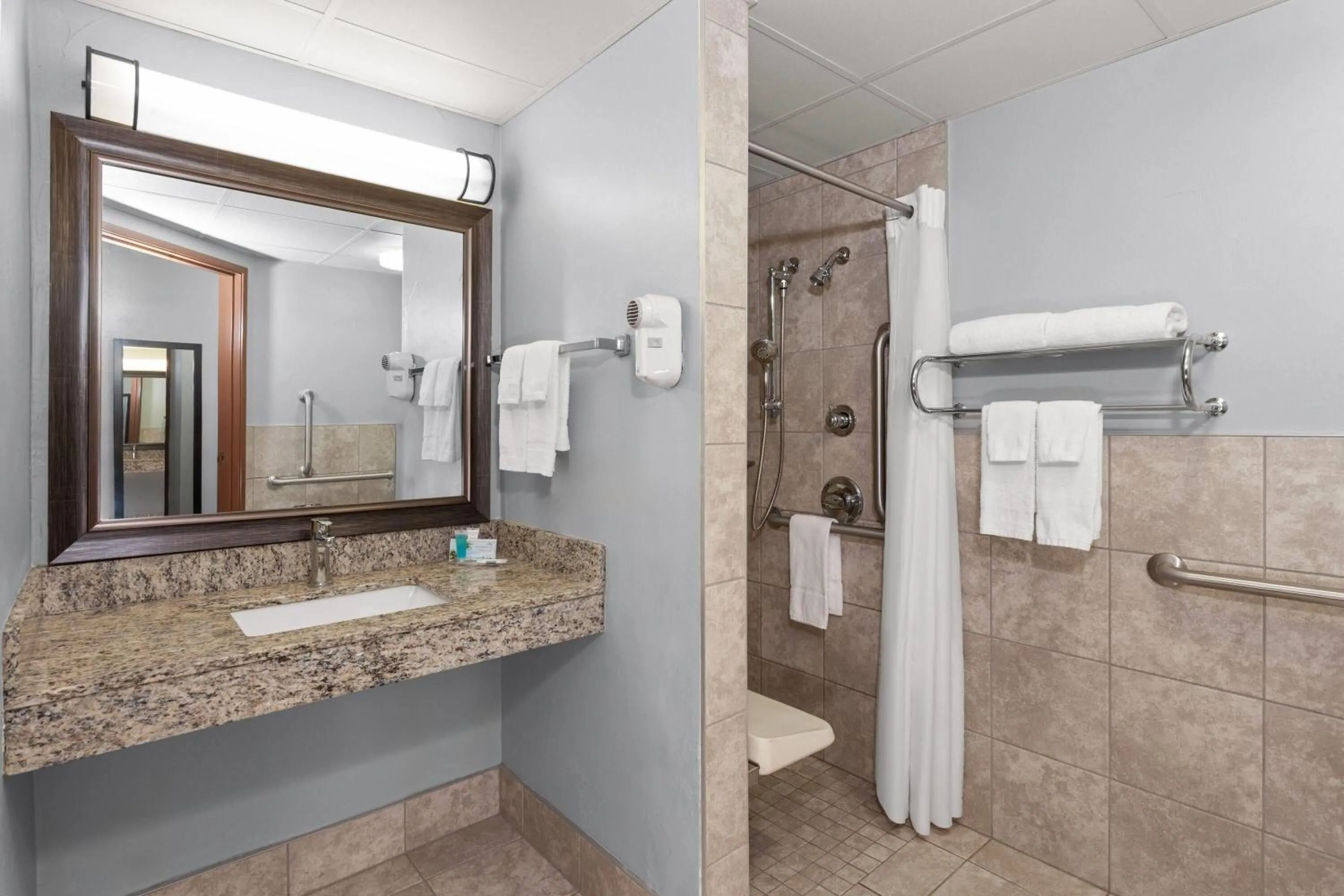 Shower in AmericInn by Wyndham Green Bay West