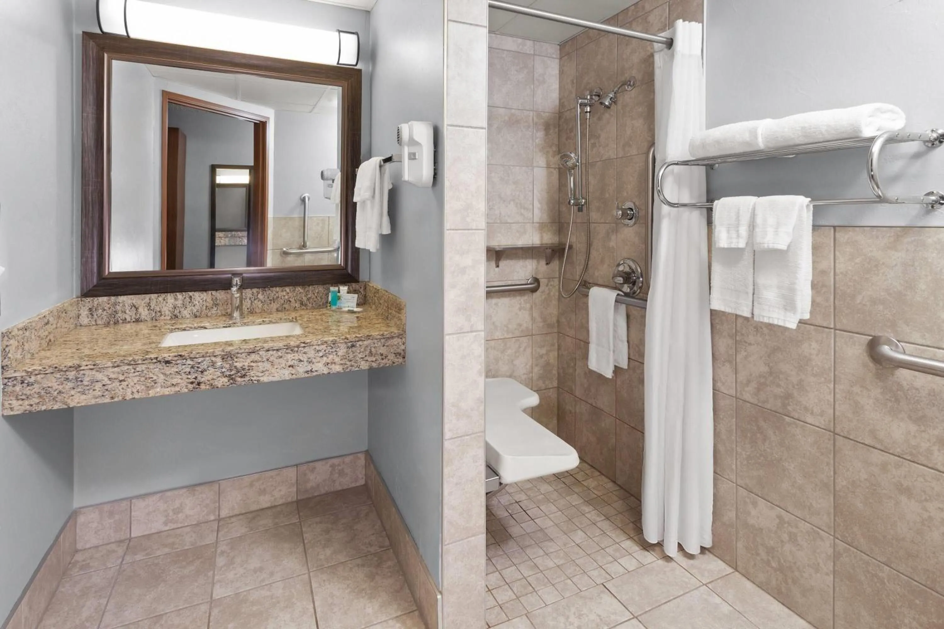 Shower in AmericInn by Wyndham Green Bay West