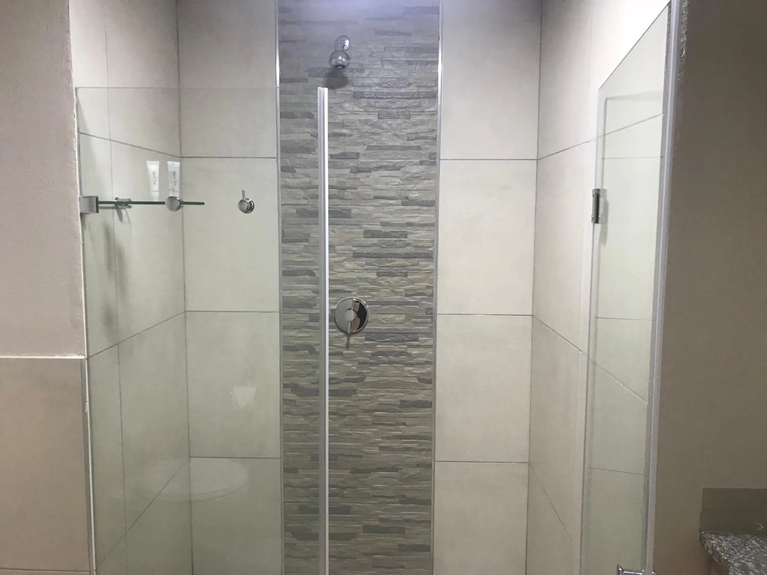 Shower in Regal Inn Hotel Midrand