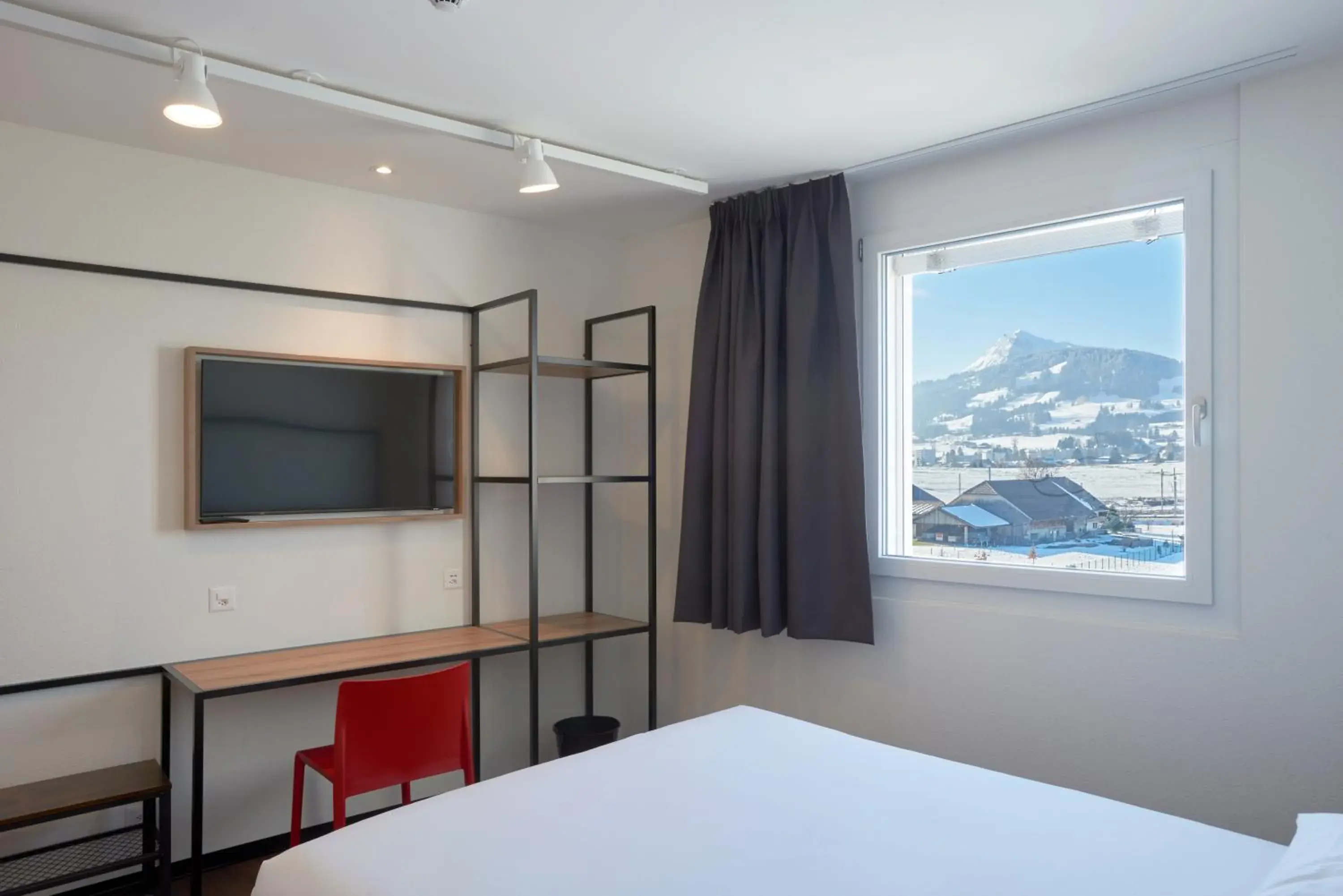 Property building, Bed in ibis Bulle - La Gruyère Swiss Bike Hotel Property building, Bed in ibis Bulle - La Gruyère Swiss Bike Hotel