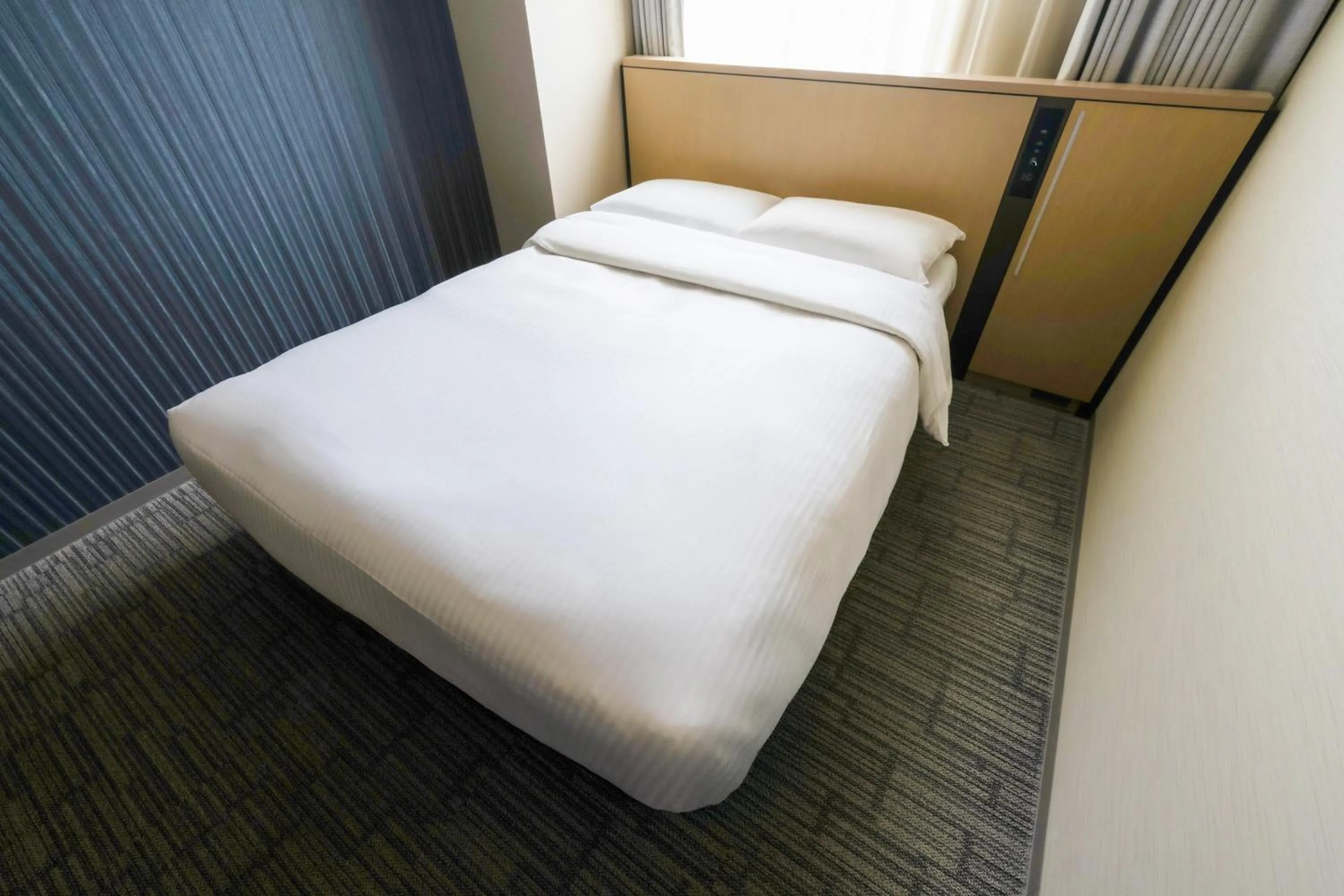 Bed in Richmond Hotel Yokohama Ekimae