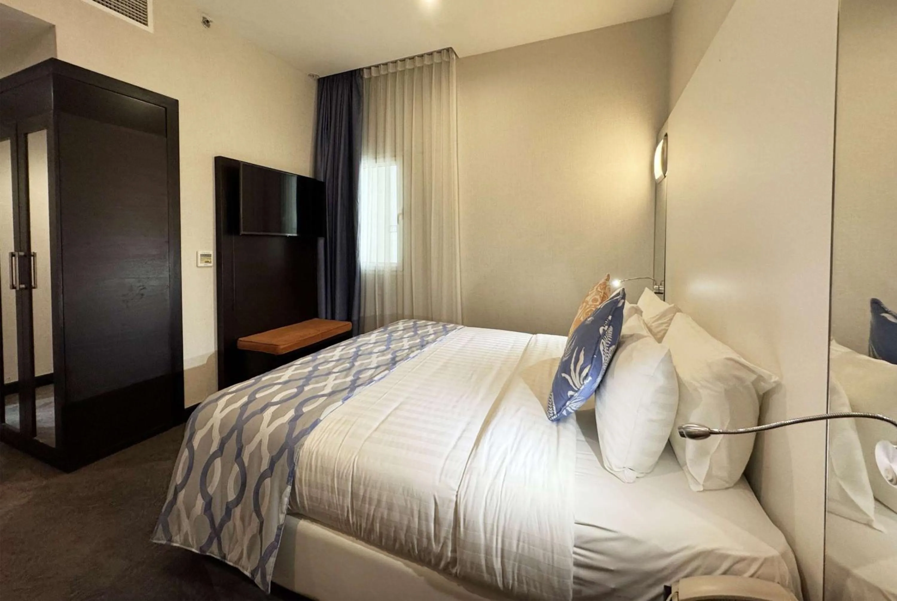 Photo of the whole room, Bed in Ramada Encore Doha by Wyndham