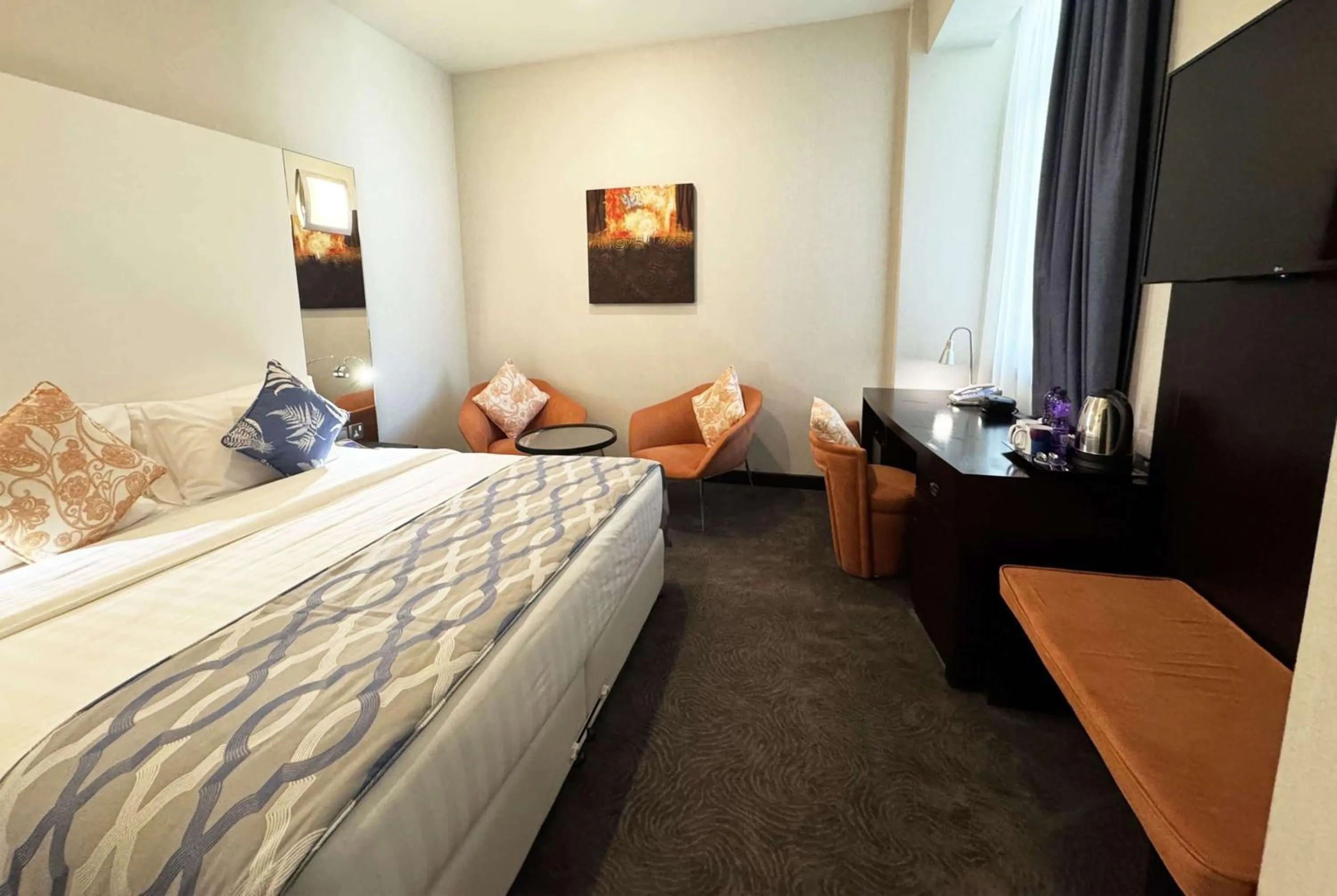 Photo of the whole room, Bed in Ramada Encore Doha by Wyndham