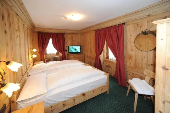 Bed in Hotel Alpina