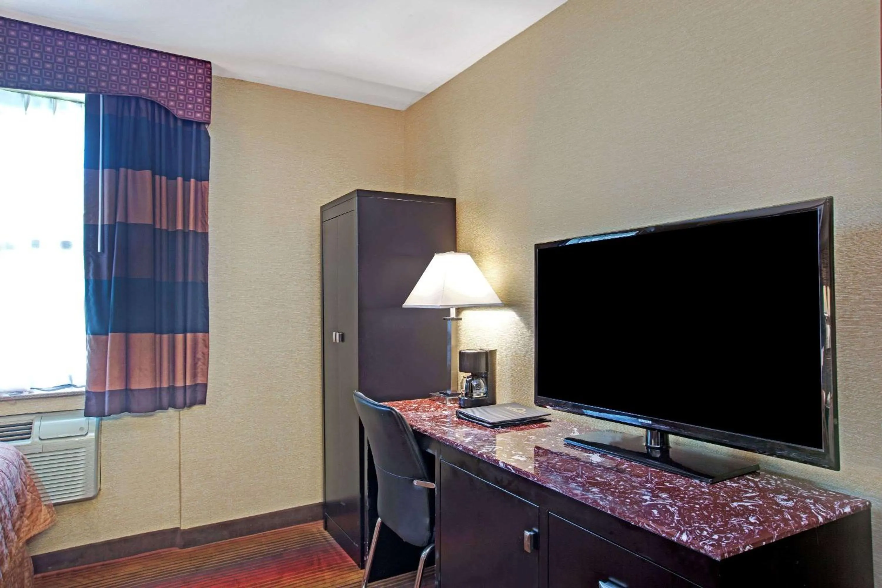 Photo of the whole room, TV/Entertainment Center in Days Inn by Wyndham Brooklyn