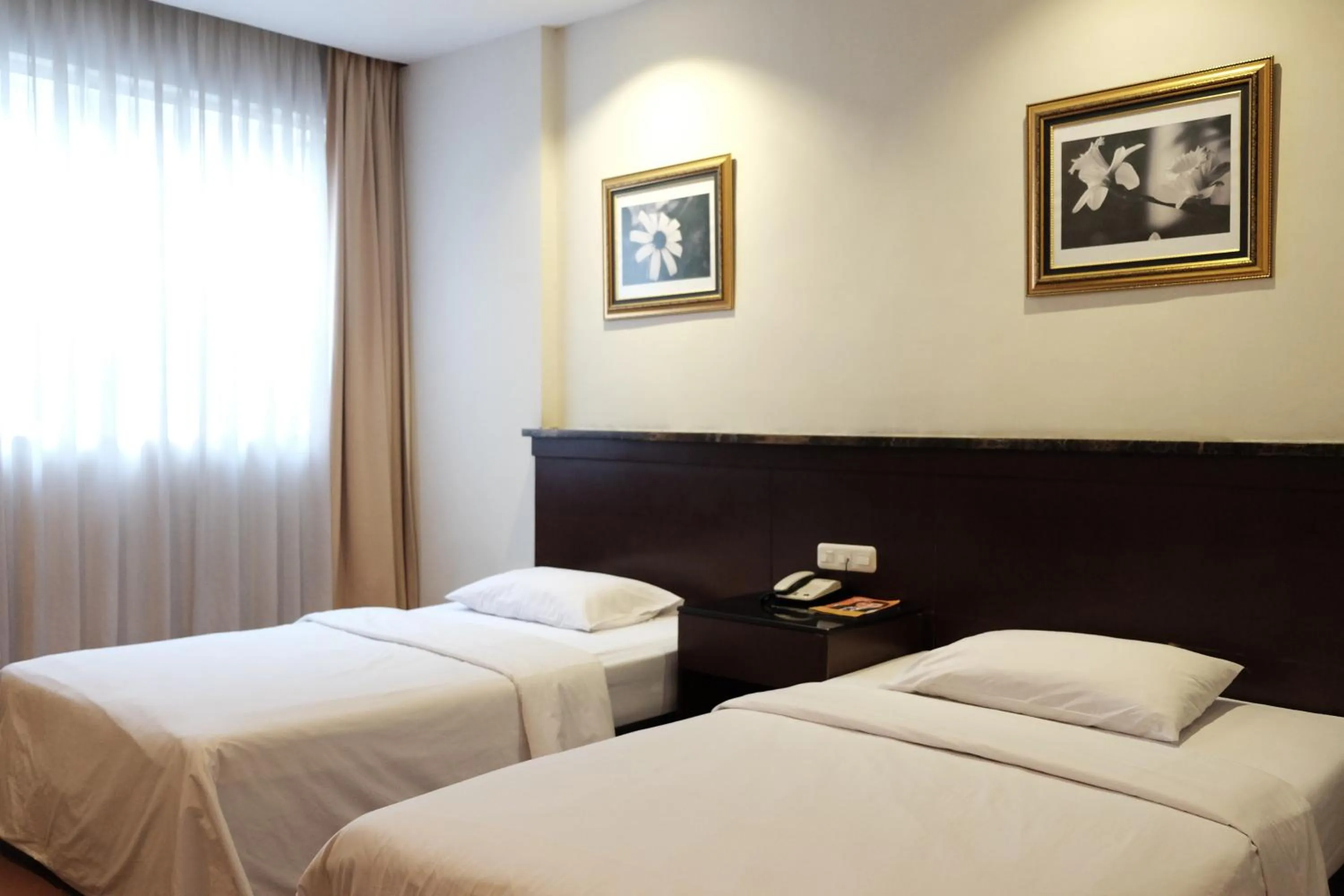 Bed in Grand Sakura Hotel