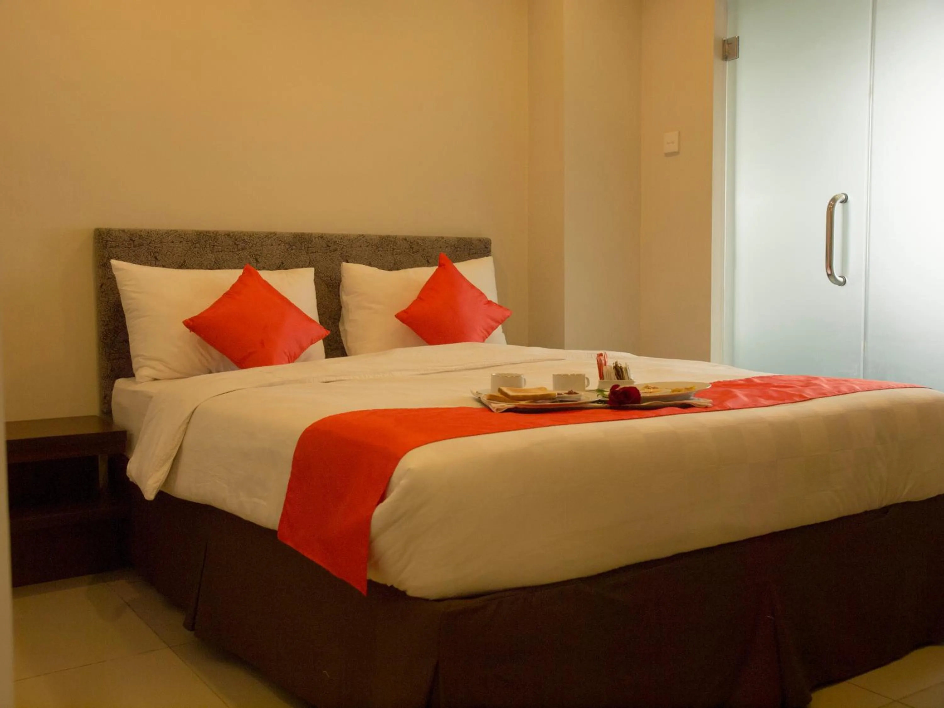 Bed in The Gloria Suites Grogol