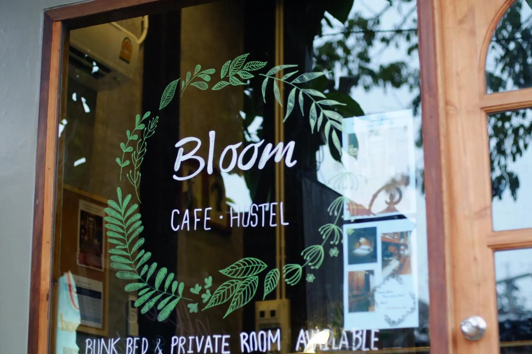 Property logo or sign in Bloom Cafe & Hostel