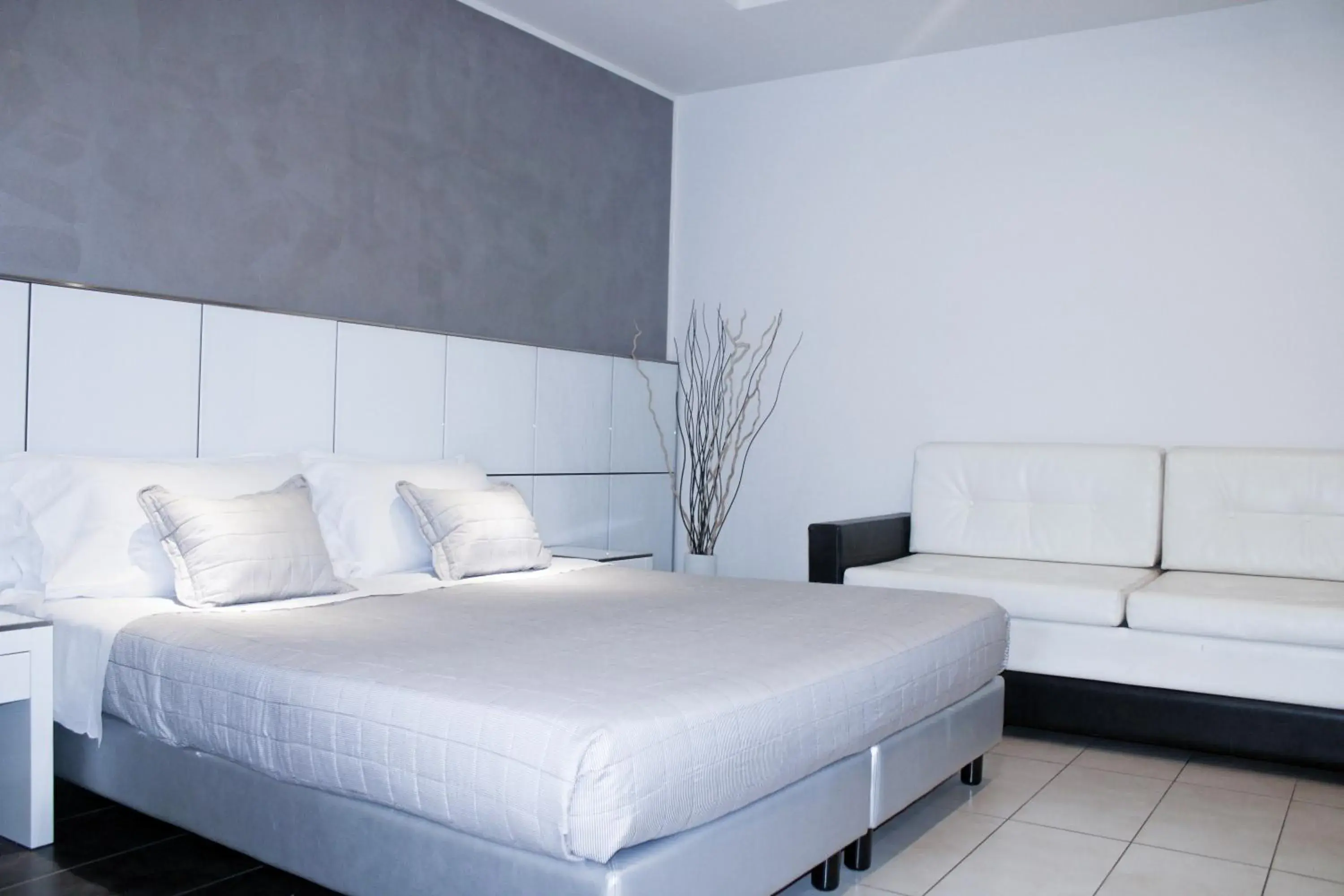 Bed in Atmosphere Suite Hotel