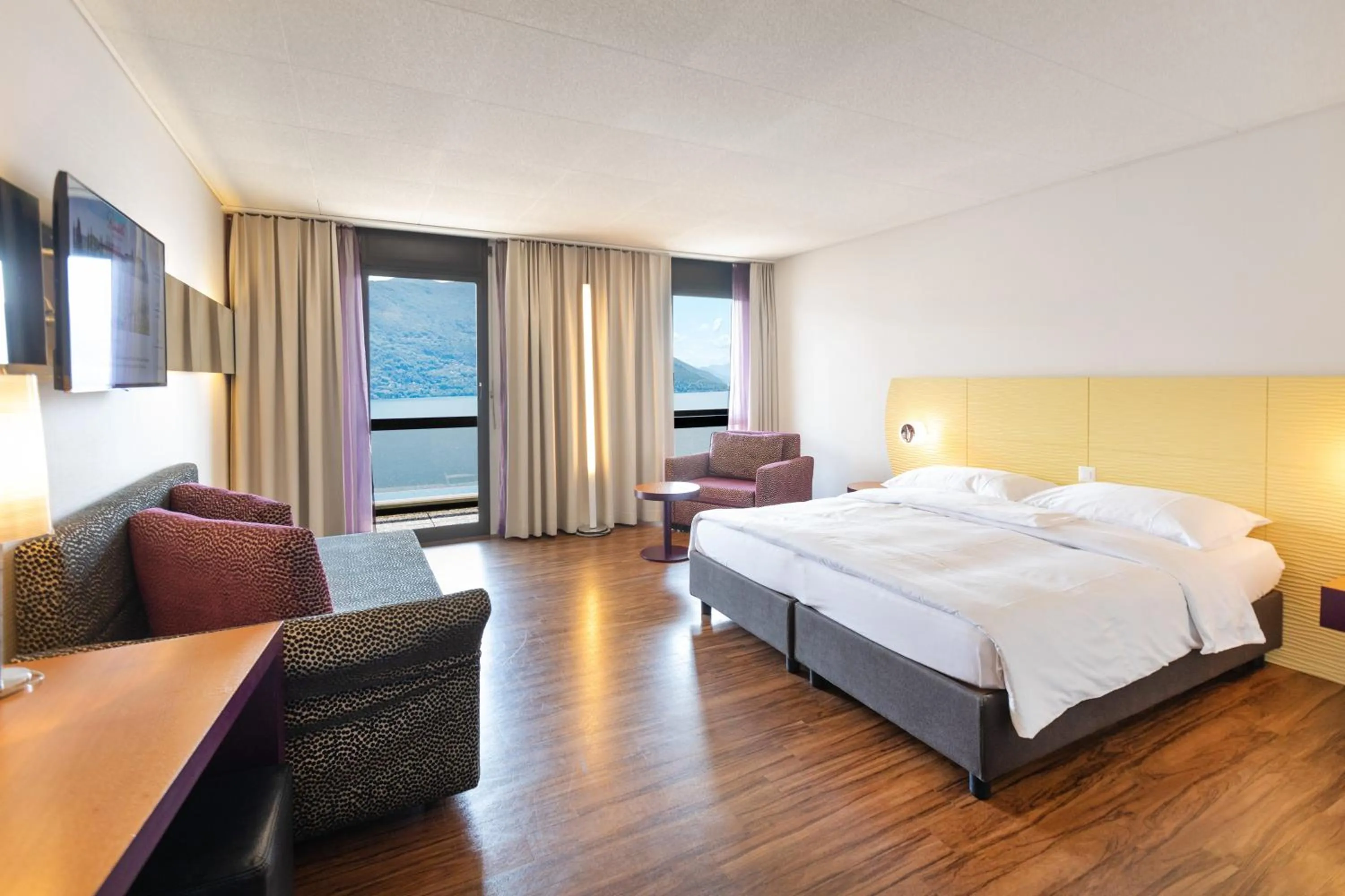 Photo of the whole room, Bed in Parkhotel Brenscino Brissago