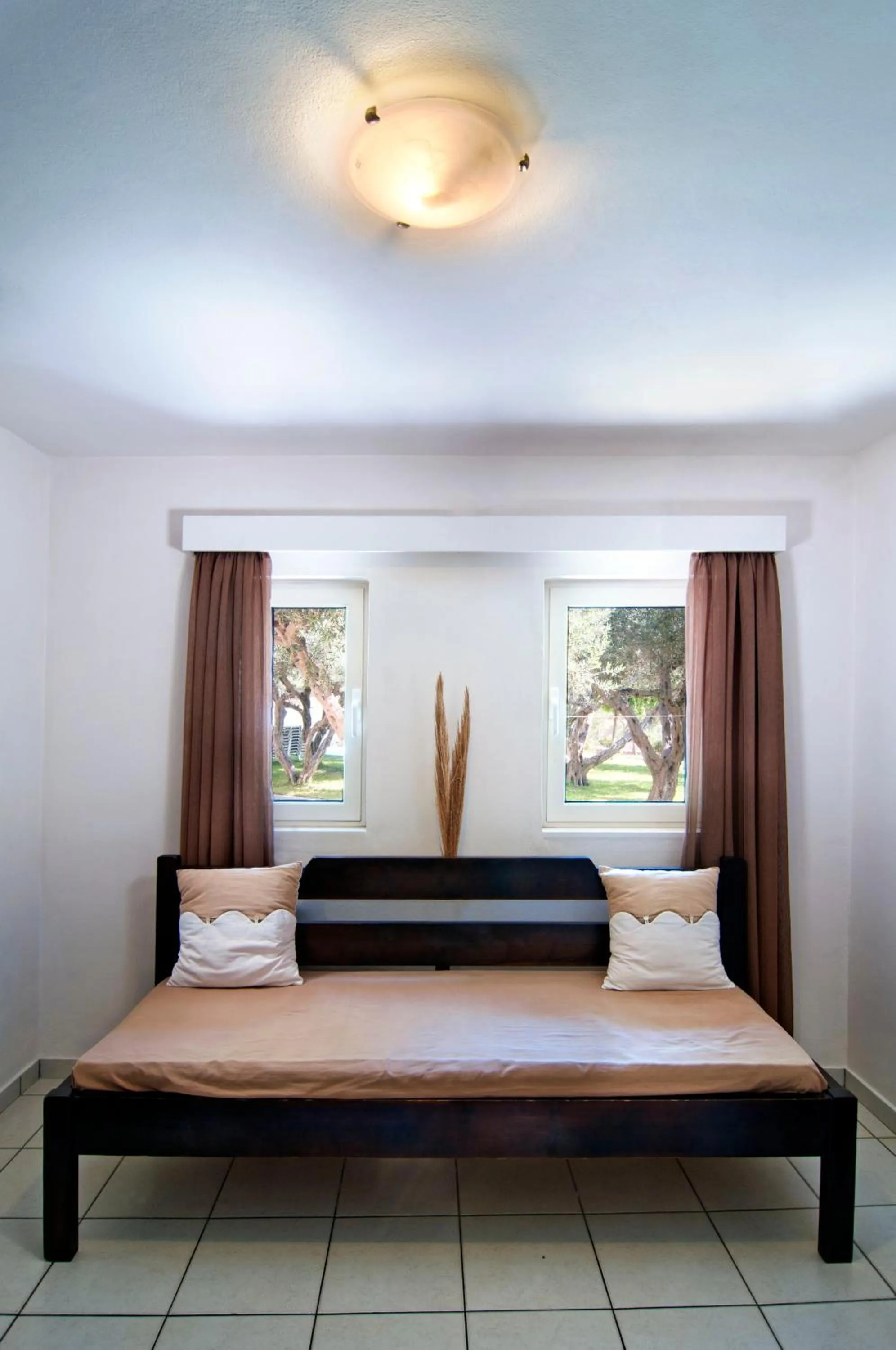 Bed in Ourania Apartments Hotel