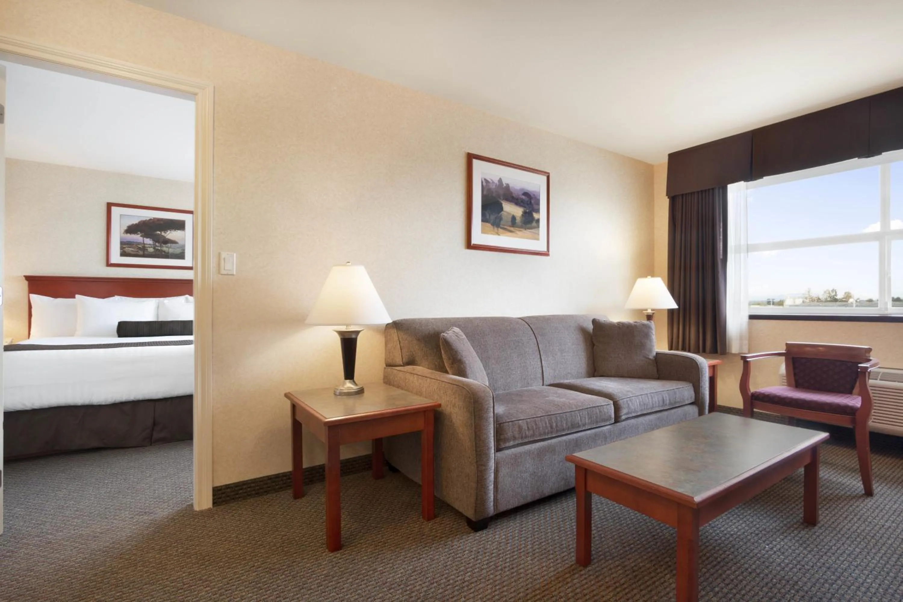 Living room, Bed in Days Inn & Suites by Wyndham Langley