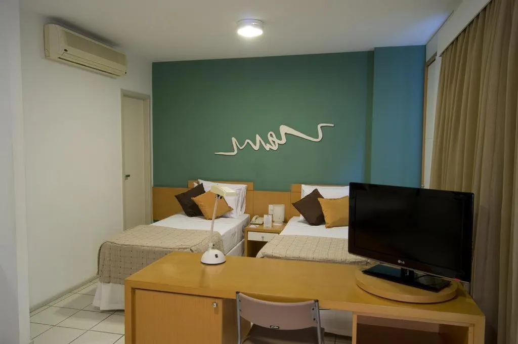 Communal lounge/ TV room, Bed in Praia do Canto Apart Hotel