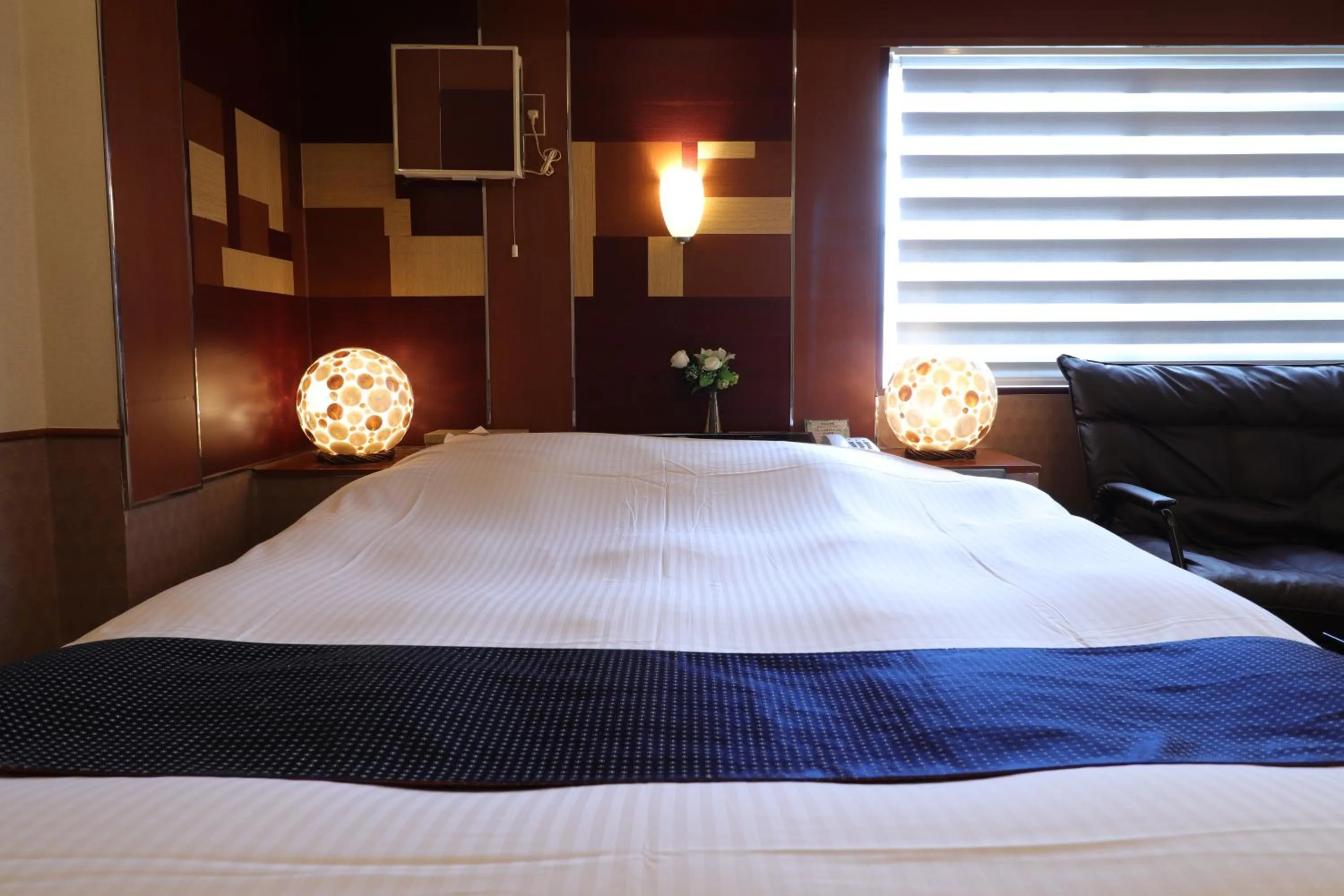 Bed in 天然個室温泉 HOTEL Lafontaine 諏訪