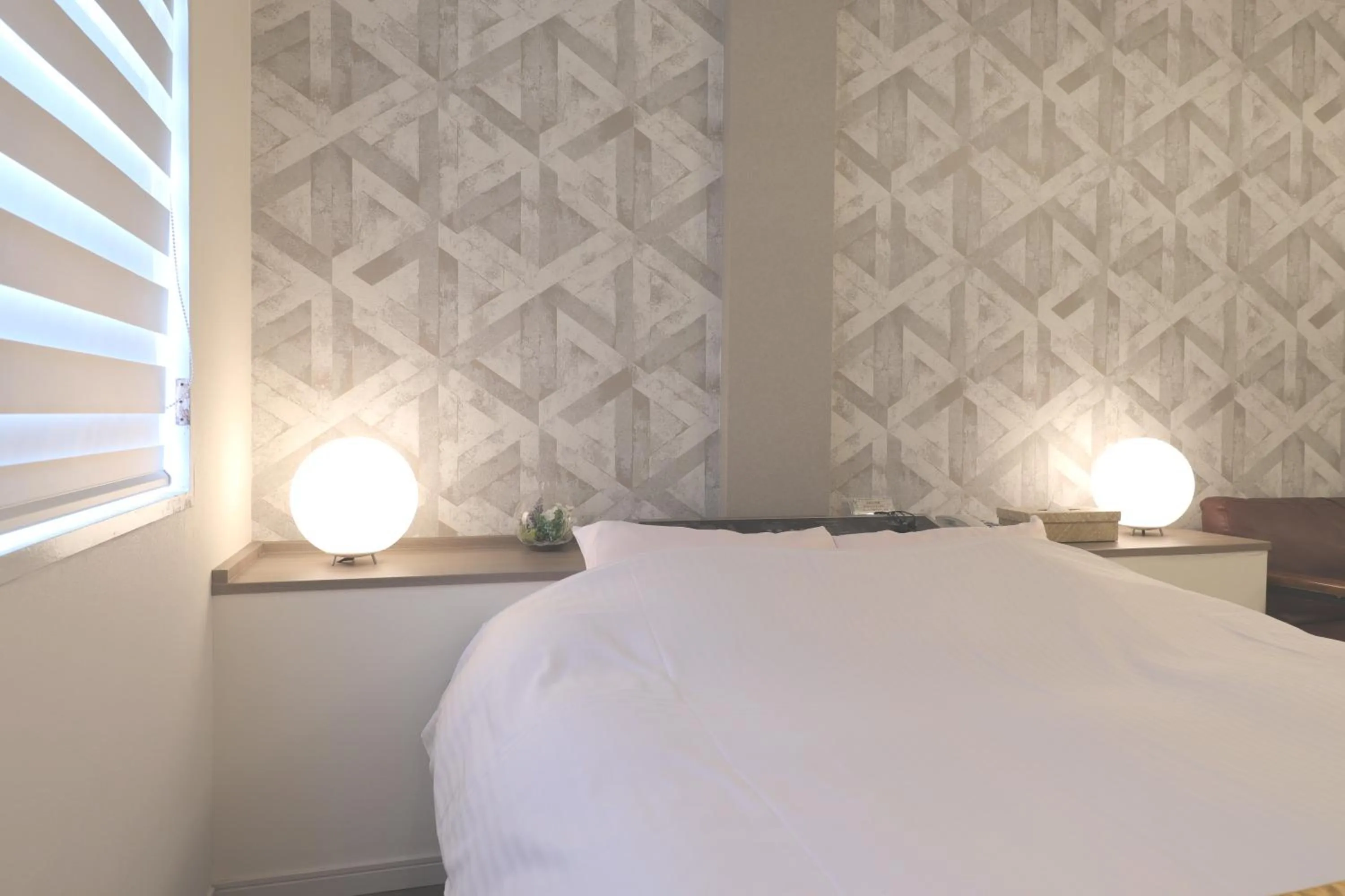 Bed in 天然個室温泉 HOTEL Lafontaine 諏訪