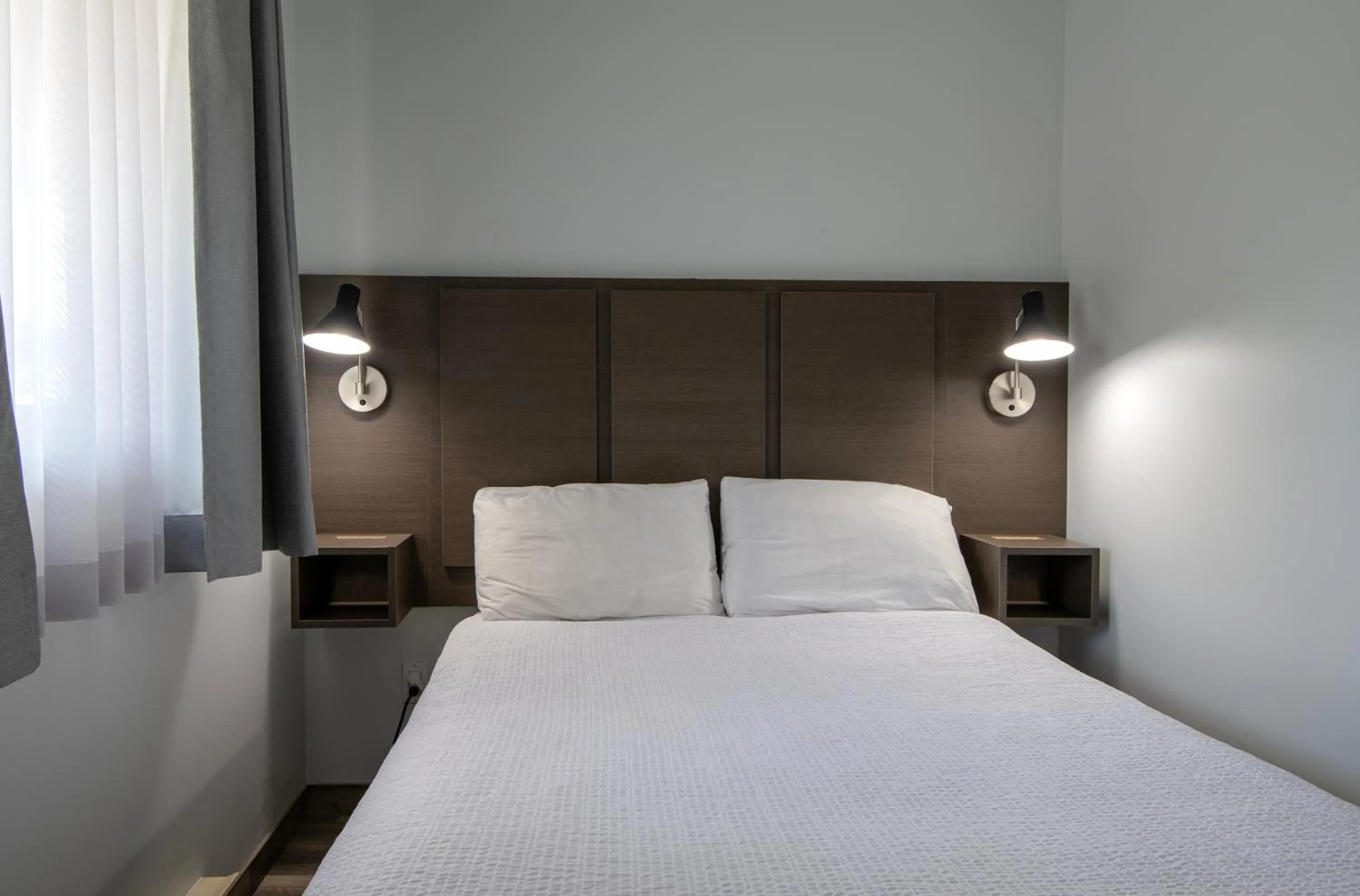 Bed in Riverland Inn & Suites