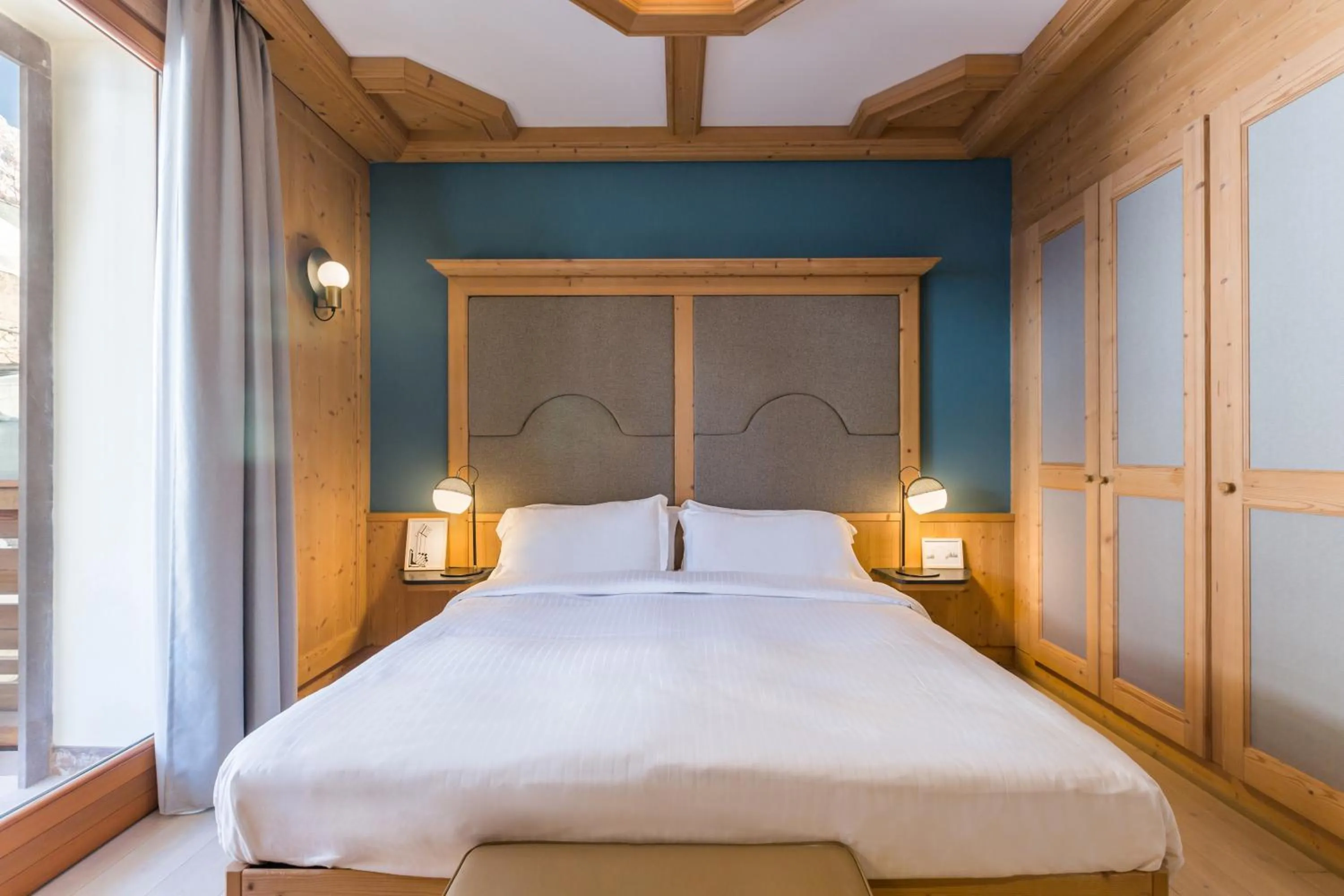 Bed in Radisson Residences Savoia Palace Cortina d’Ampezzo