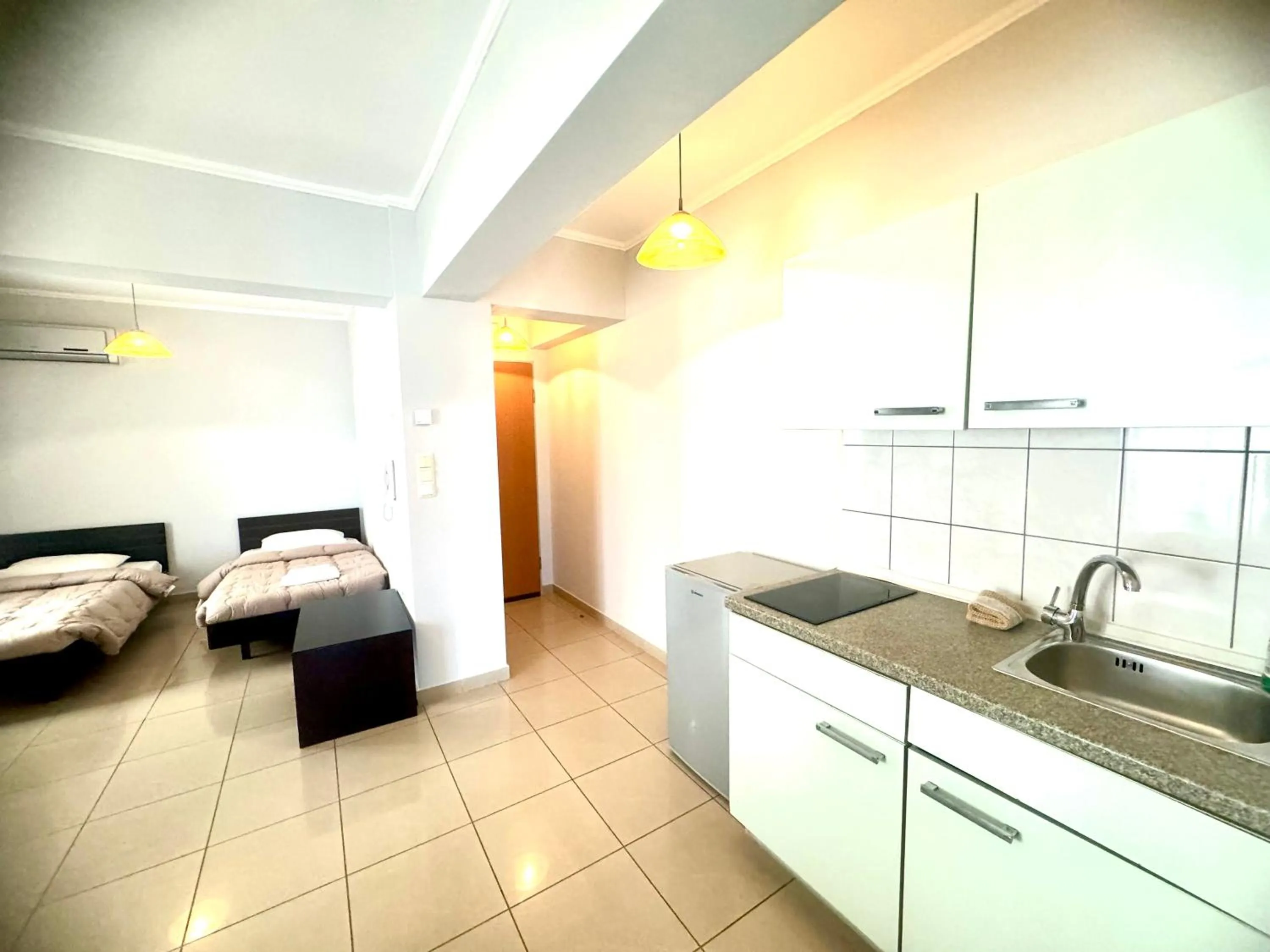 Kitchen or kitchenette, Bed in Comfort Hotel Apartments