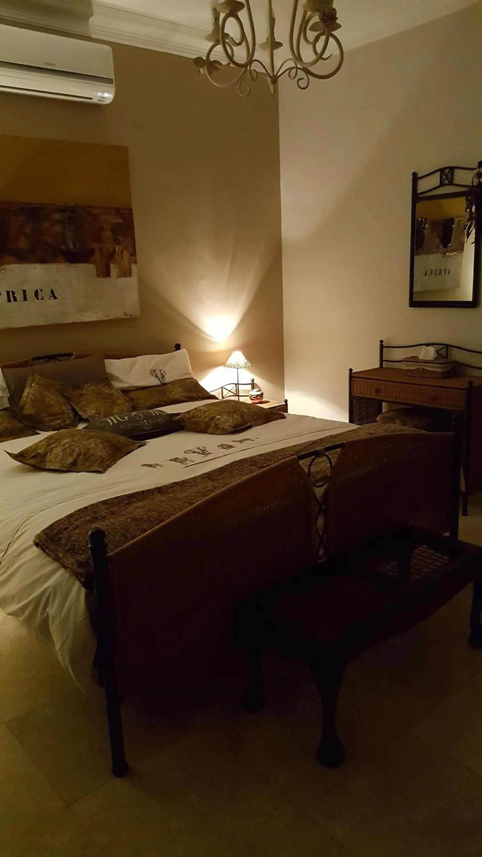 Bedroom in African Palm Cottage and Guesthouse
