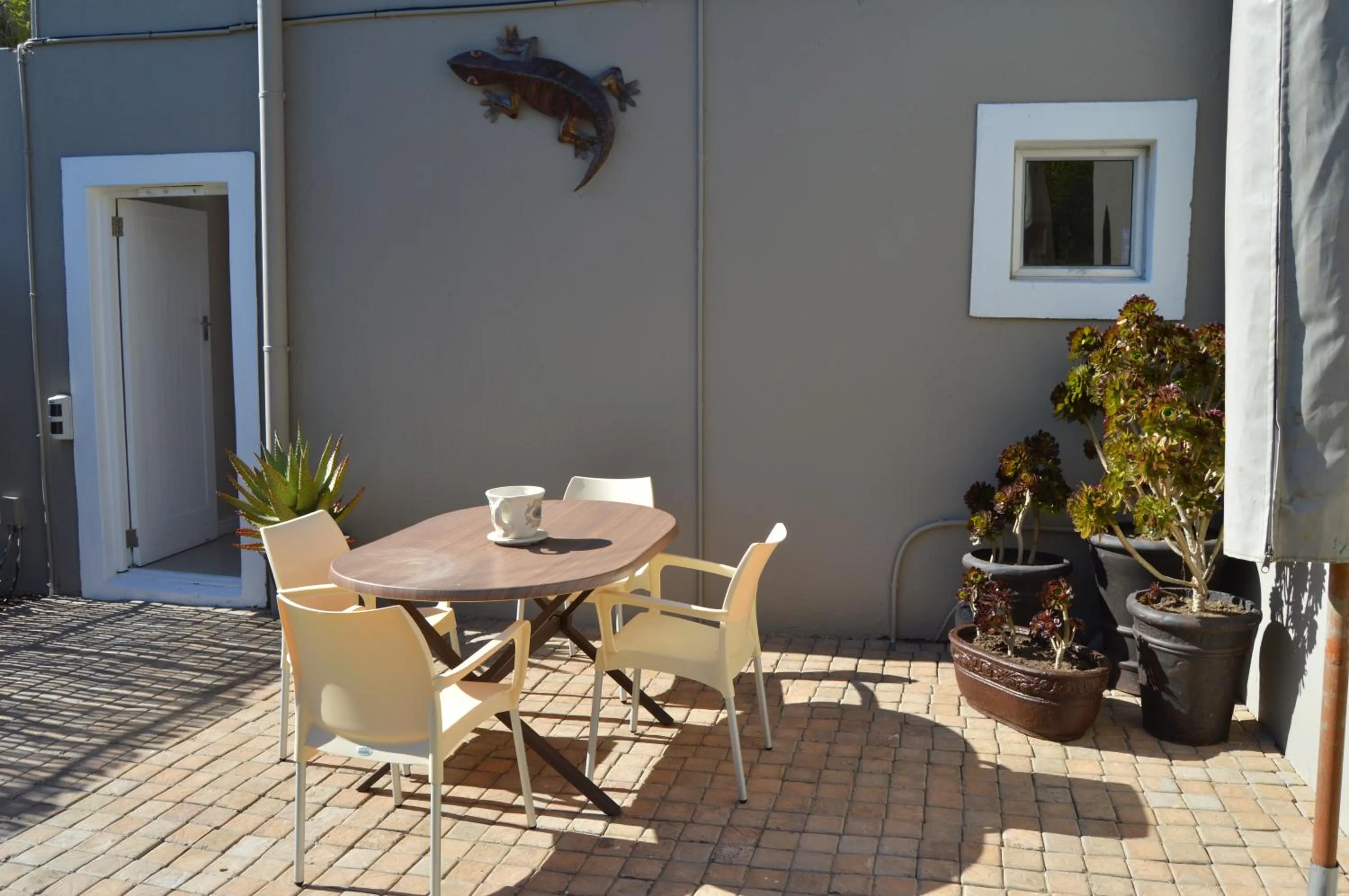 Balcony/Terrace in African Palm Cottage and Guesthouse