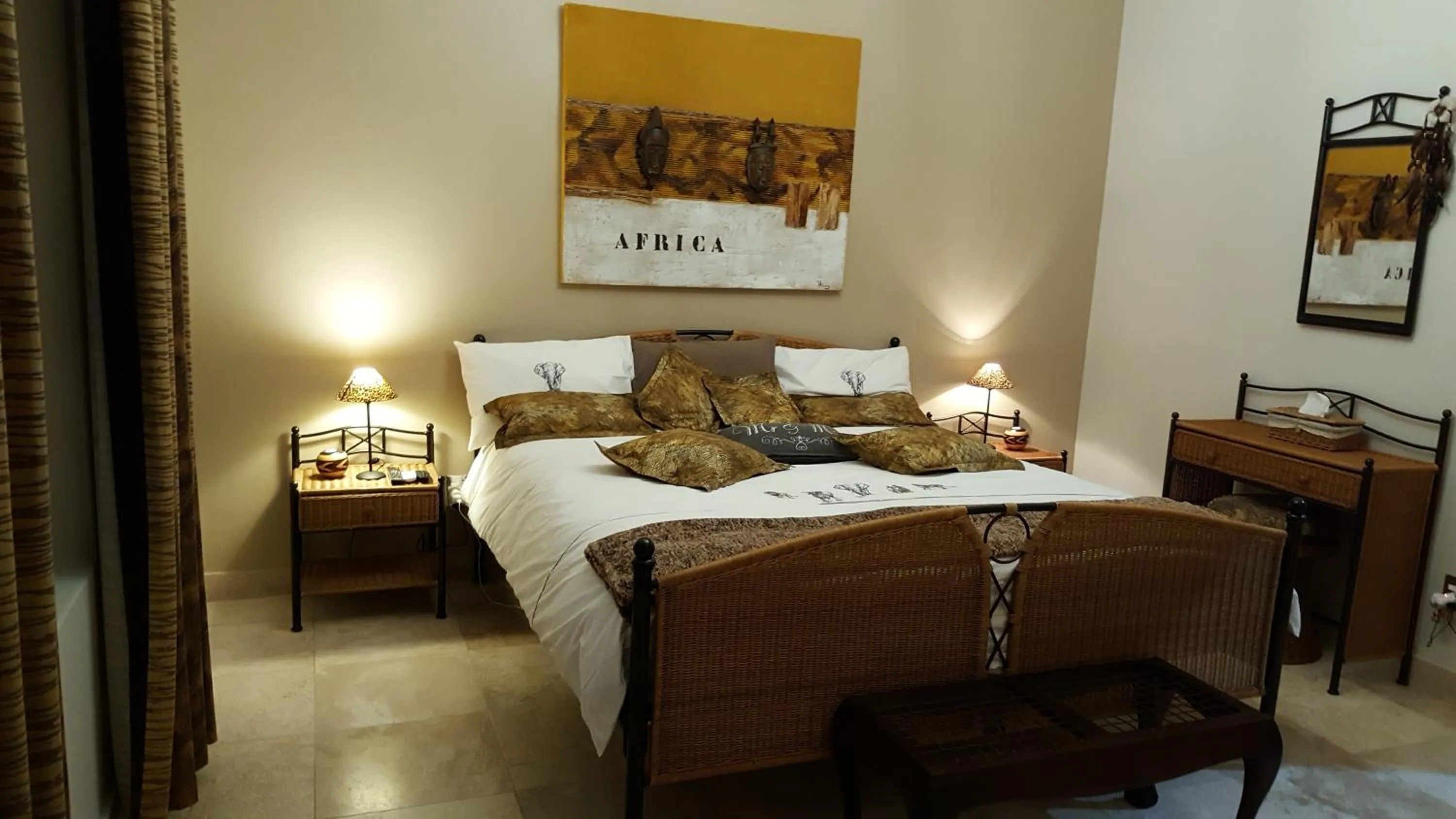 Bedroom in African Palm Cottage and Guesthouse