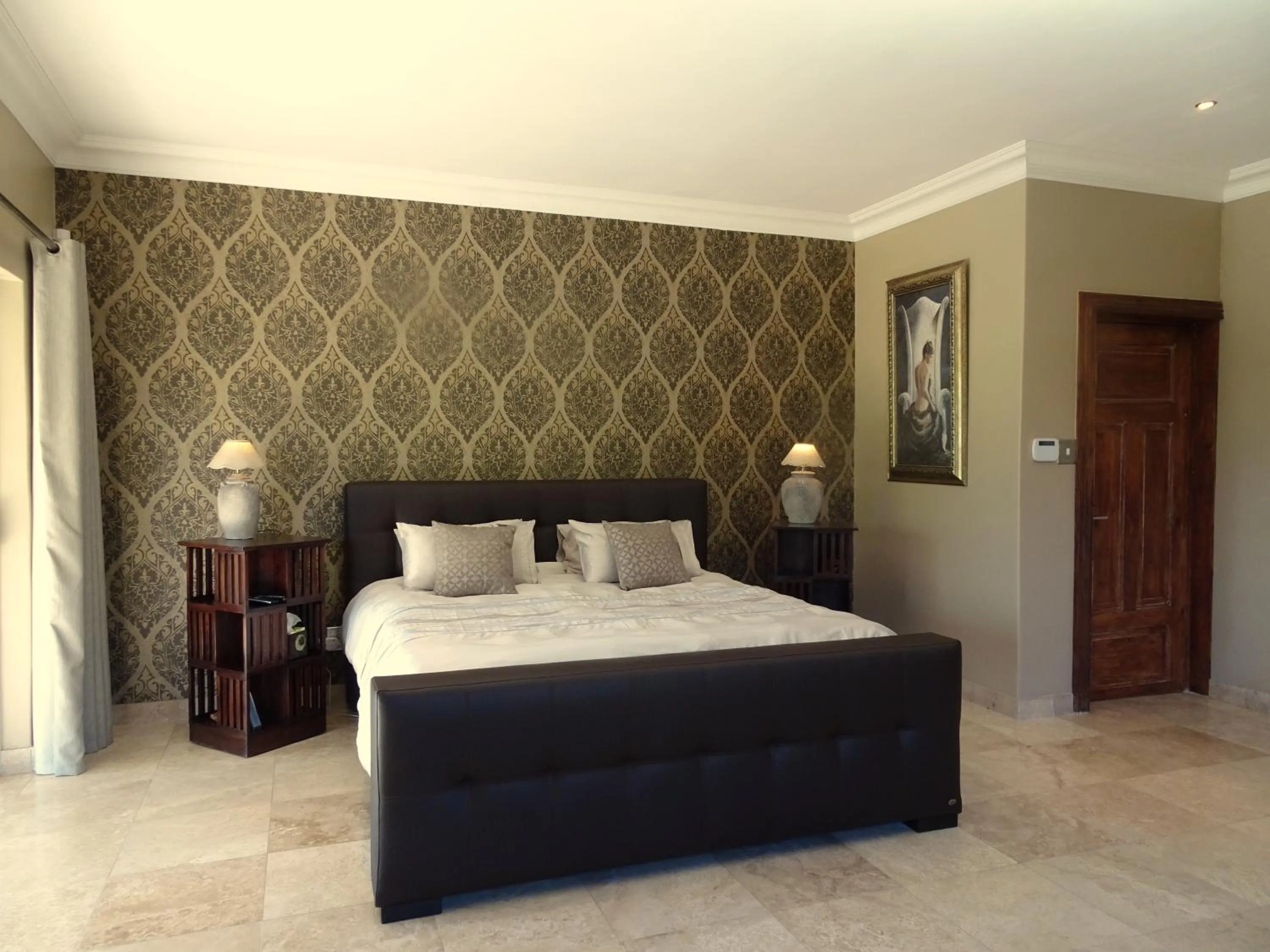 Bedroom in African Palm Cottage and Guesthouse