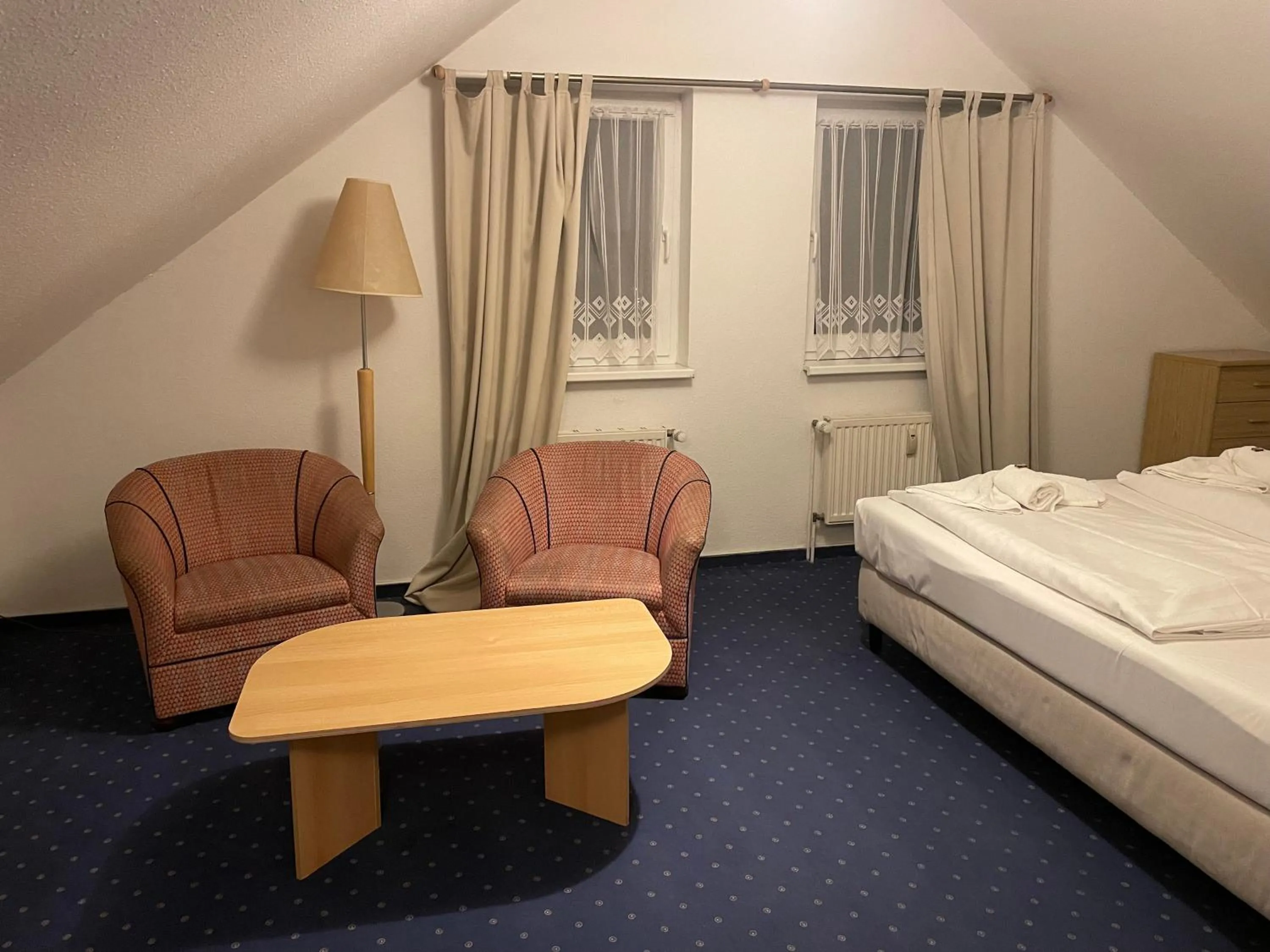 Seating area, Bed in Hotel Zum Strand