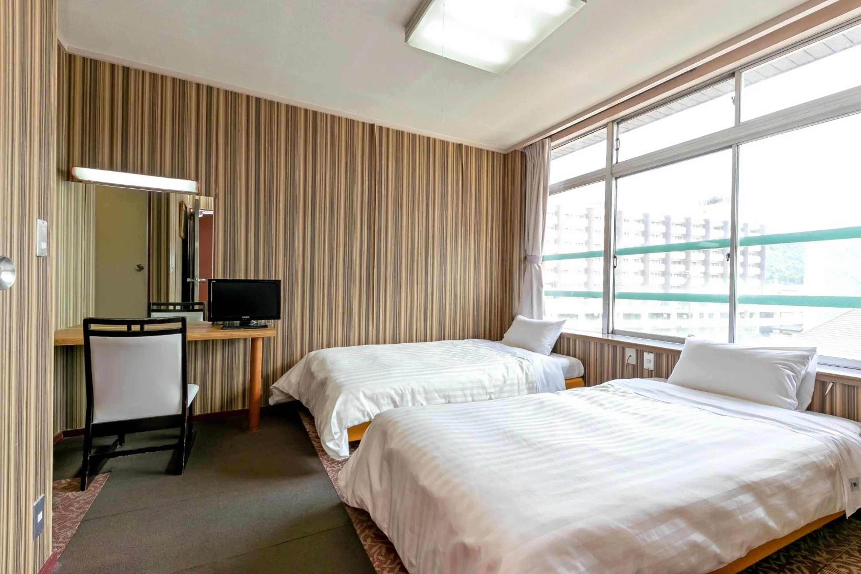 Bed in Itoen Hotel New Sakura