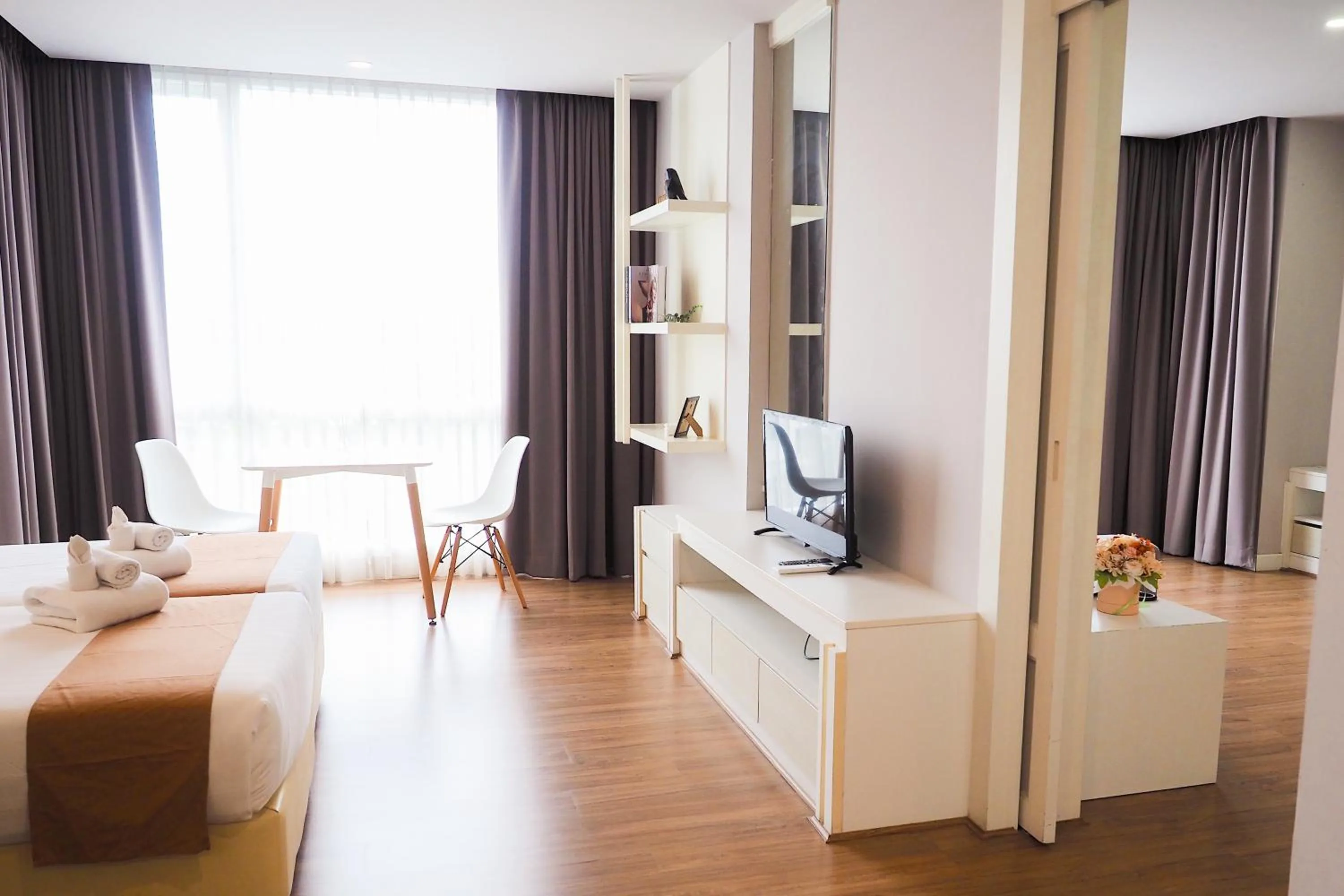 Communal lounge/ TV room, Bed in THE KANNAS Hotel & Serviced Apartment, Chiang Mai SHA Certified