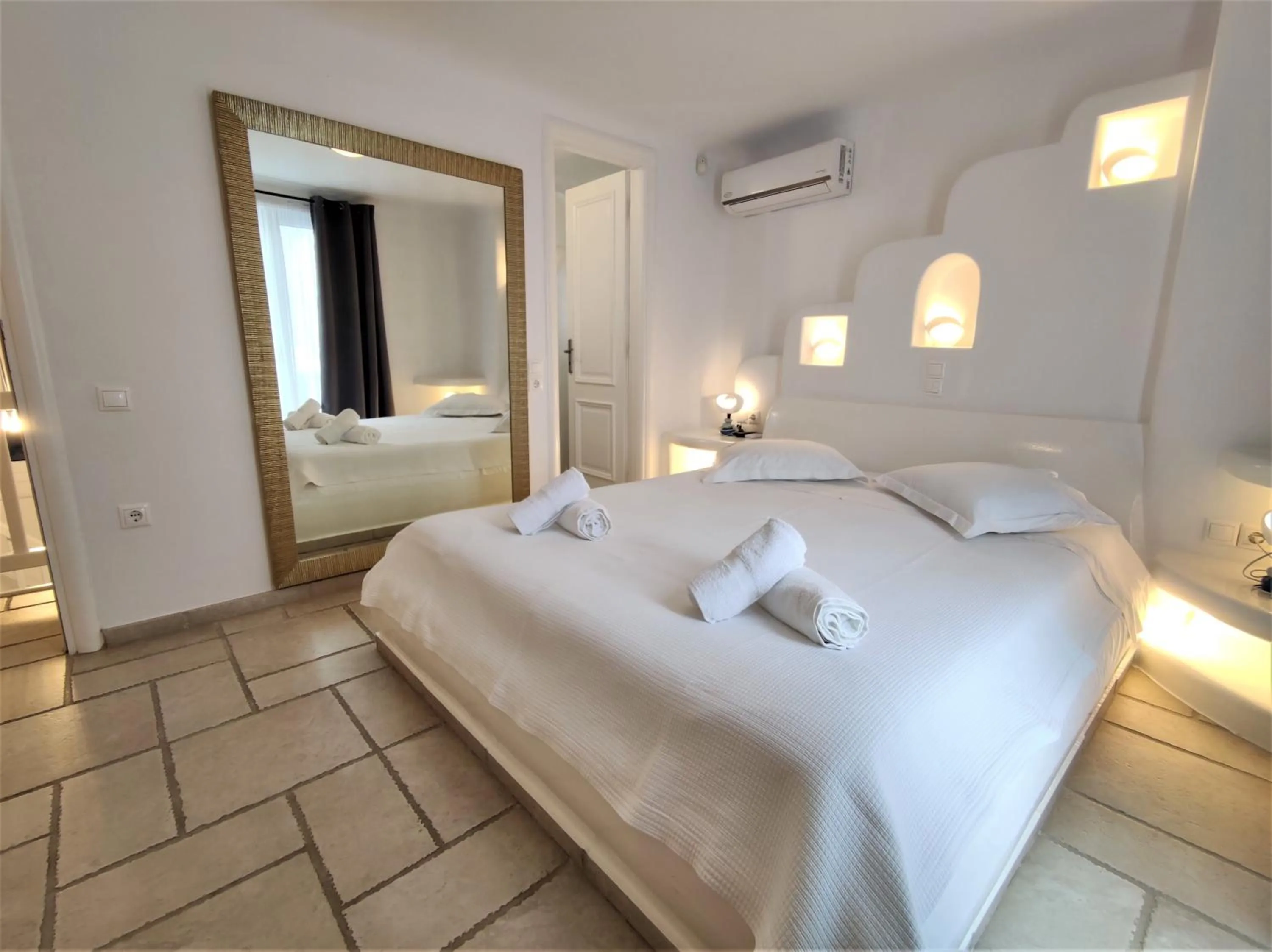 Bed in Mykonian Iros Suites & Villas