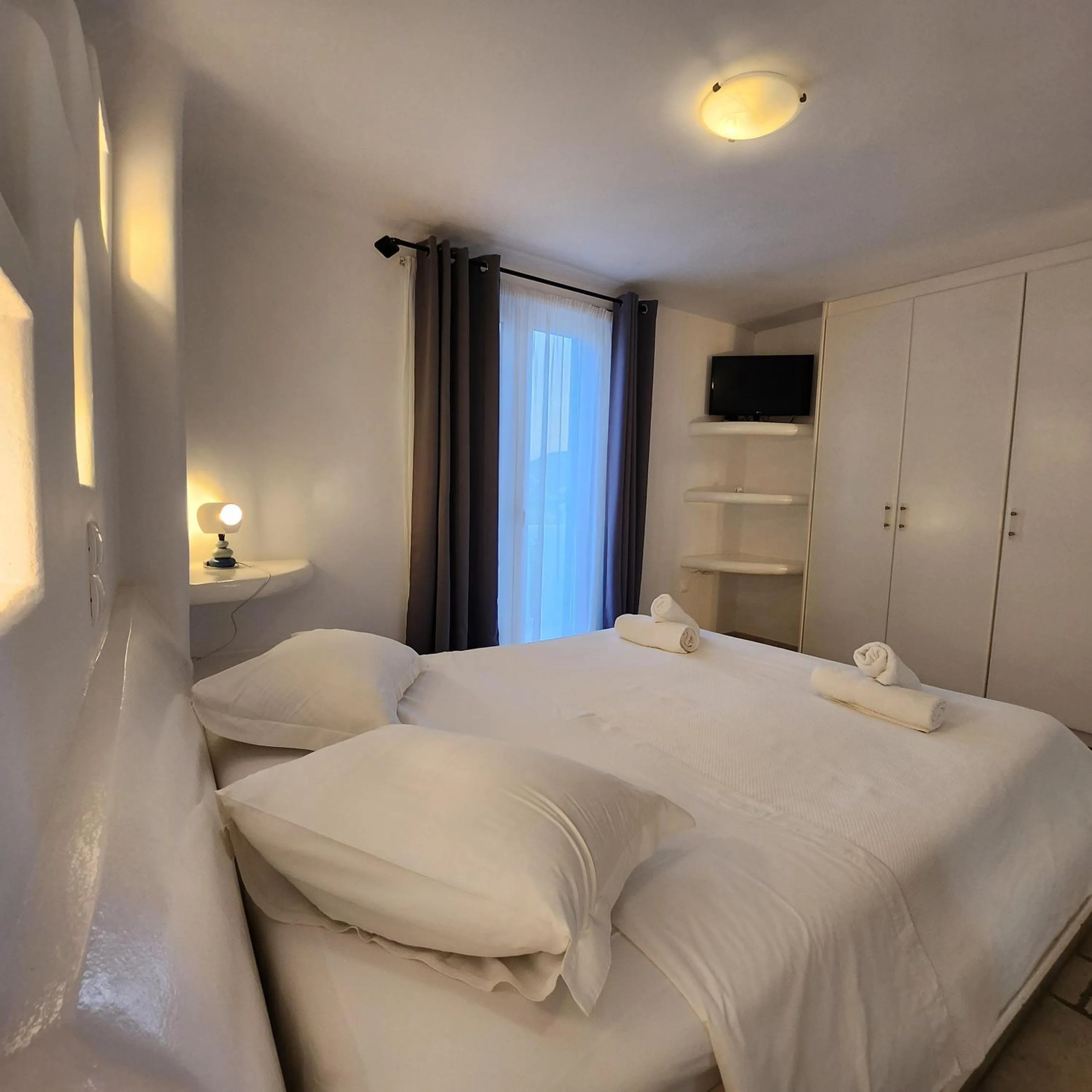 Bed in Mykonian Iros Suites & Villas