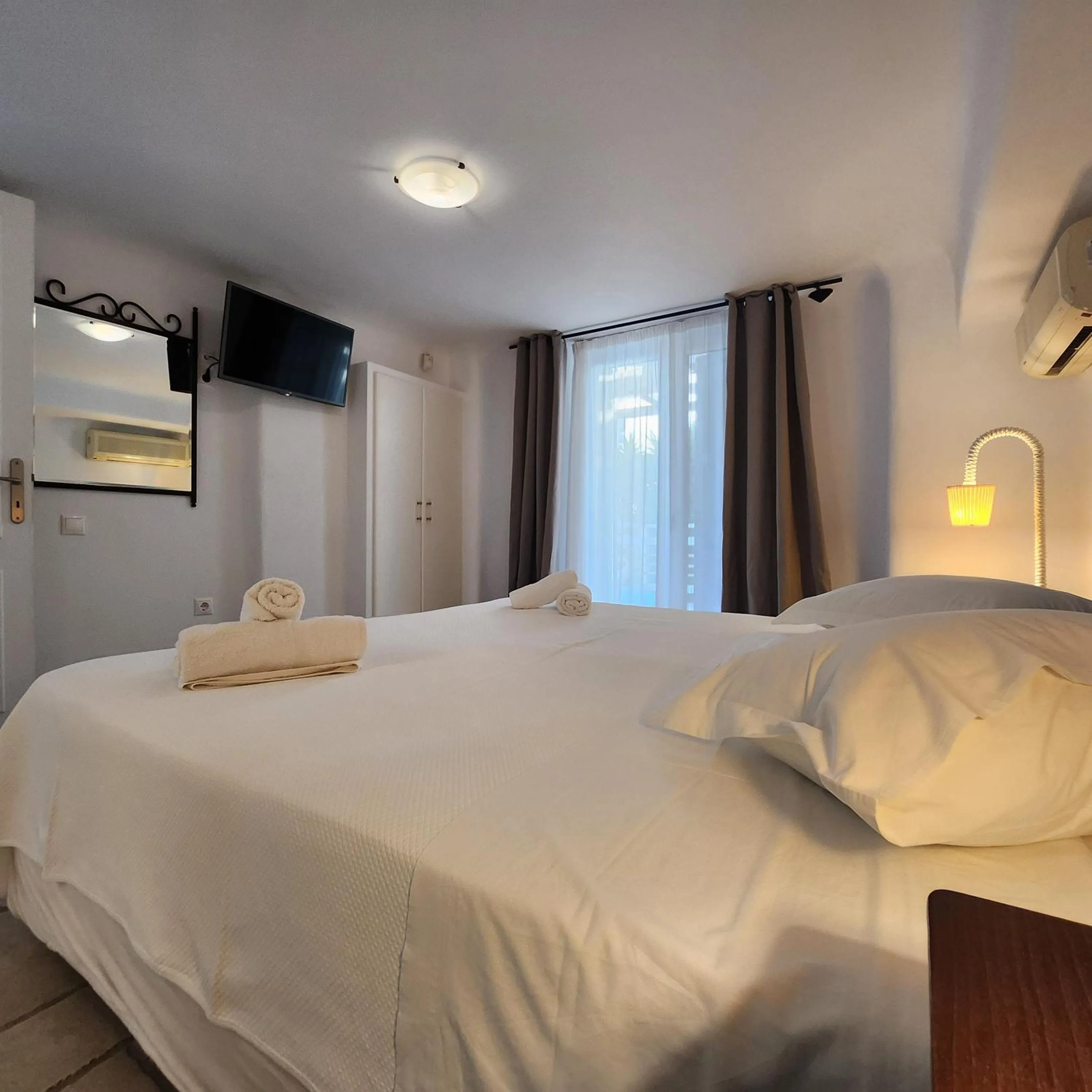 Bed in Mykonian Iros Suites & Villas