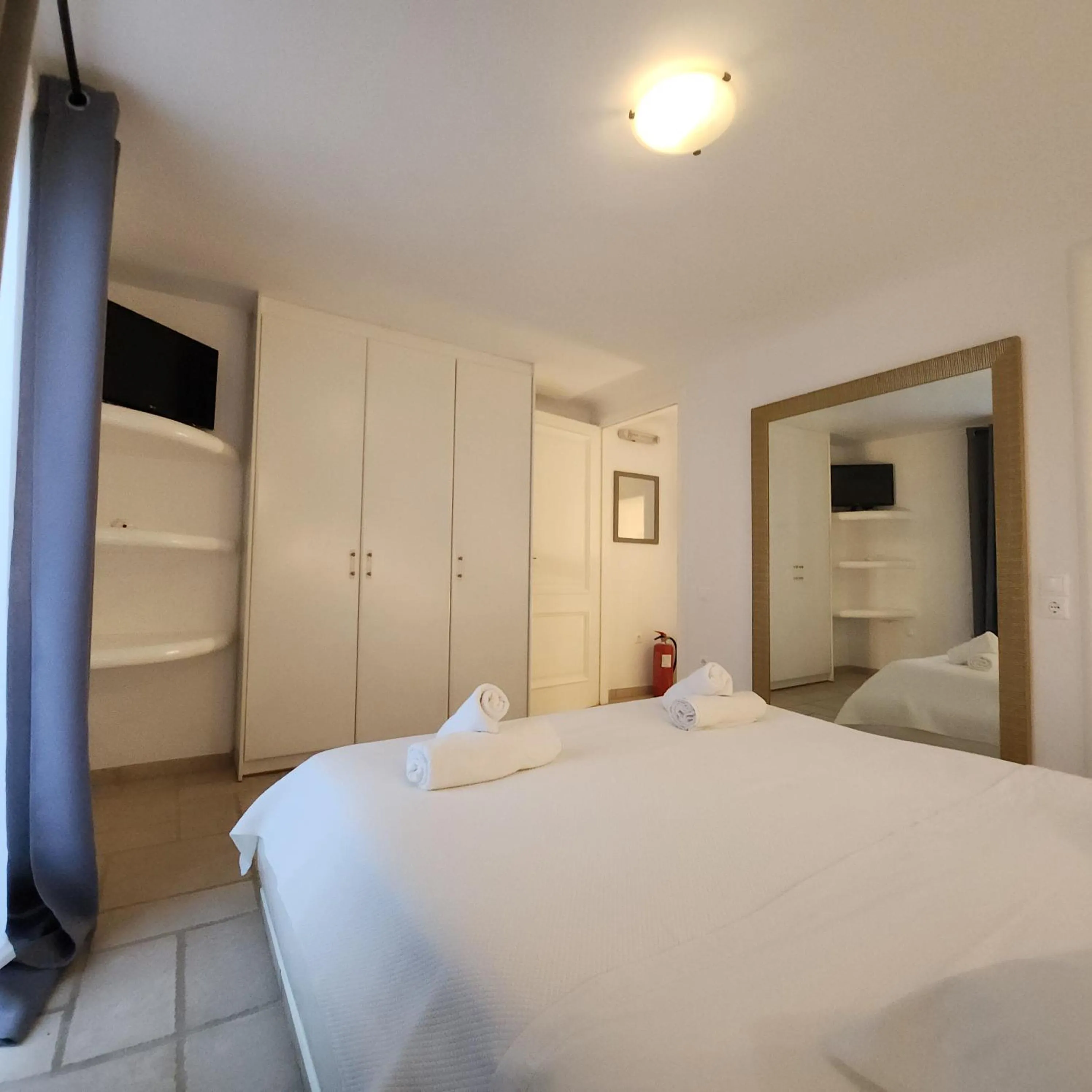 Bed in Mykonian Iros Suites & Villas