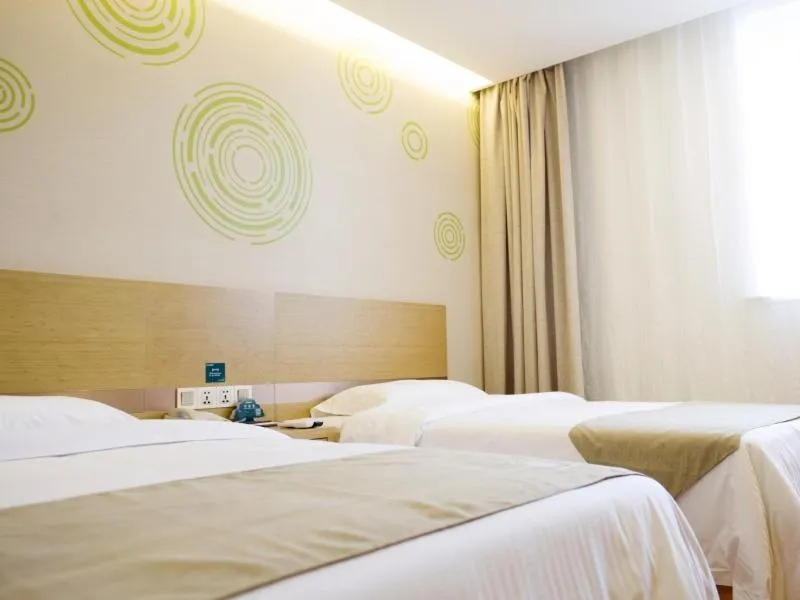 Bed in GreenTree Inn Nantong Qidong Lvsi Harbour Express Hotel