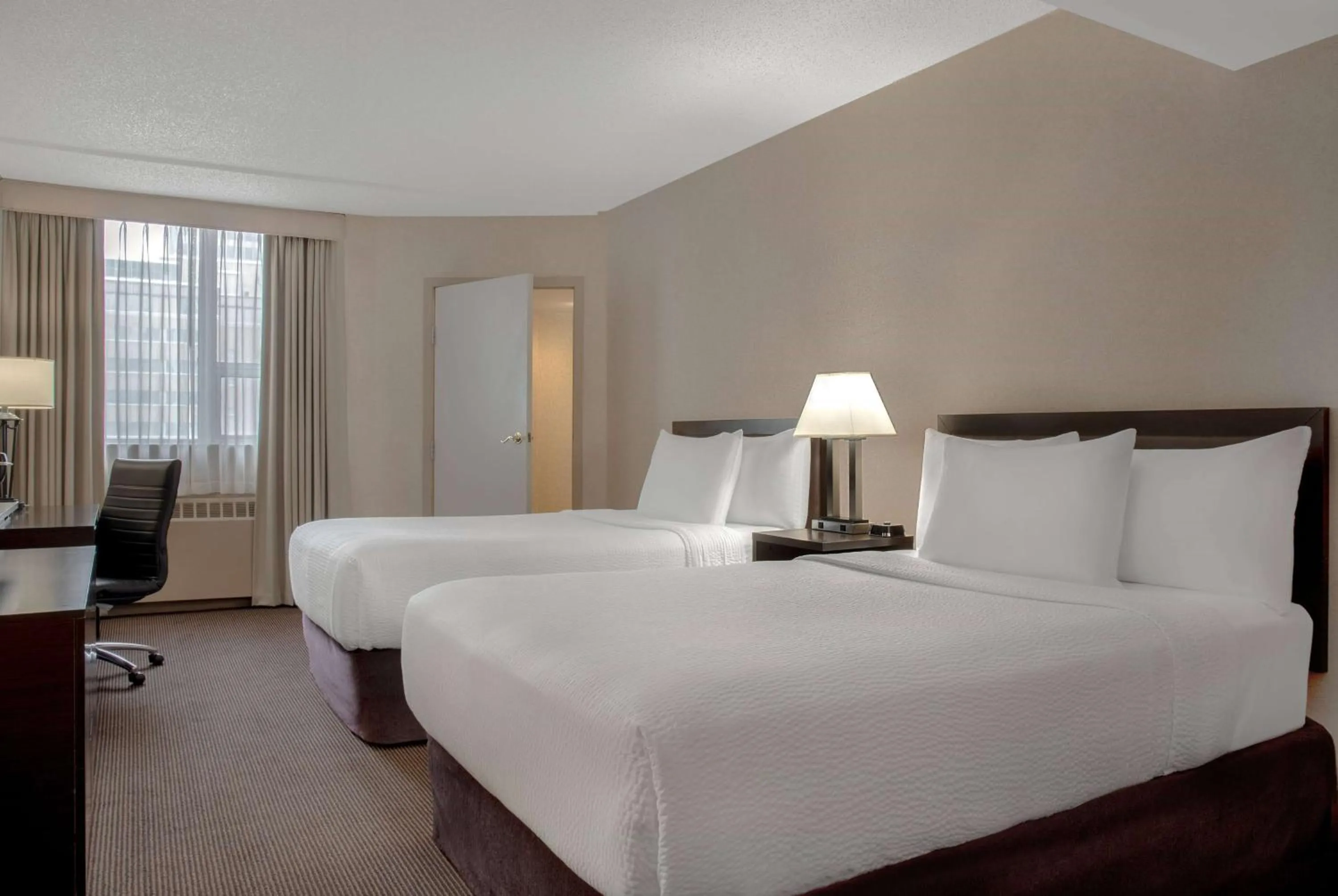 Photo of the whole room, Bed in Ramada Plaza by Wyndham Calgary Downtown